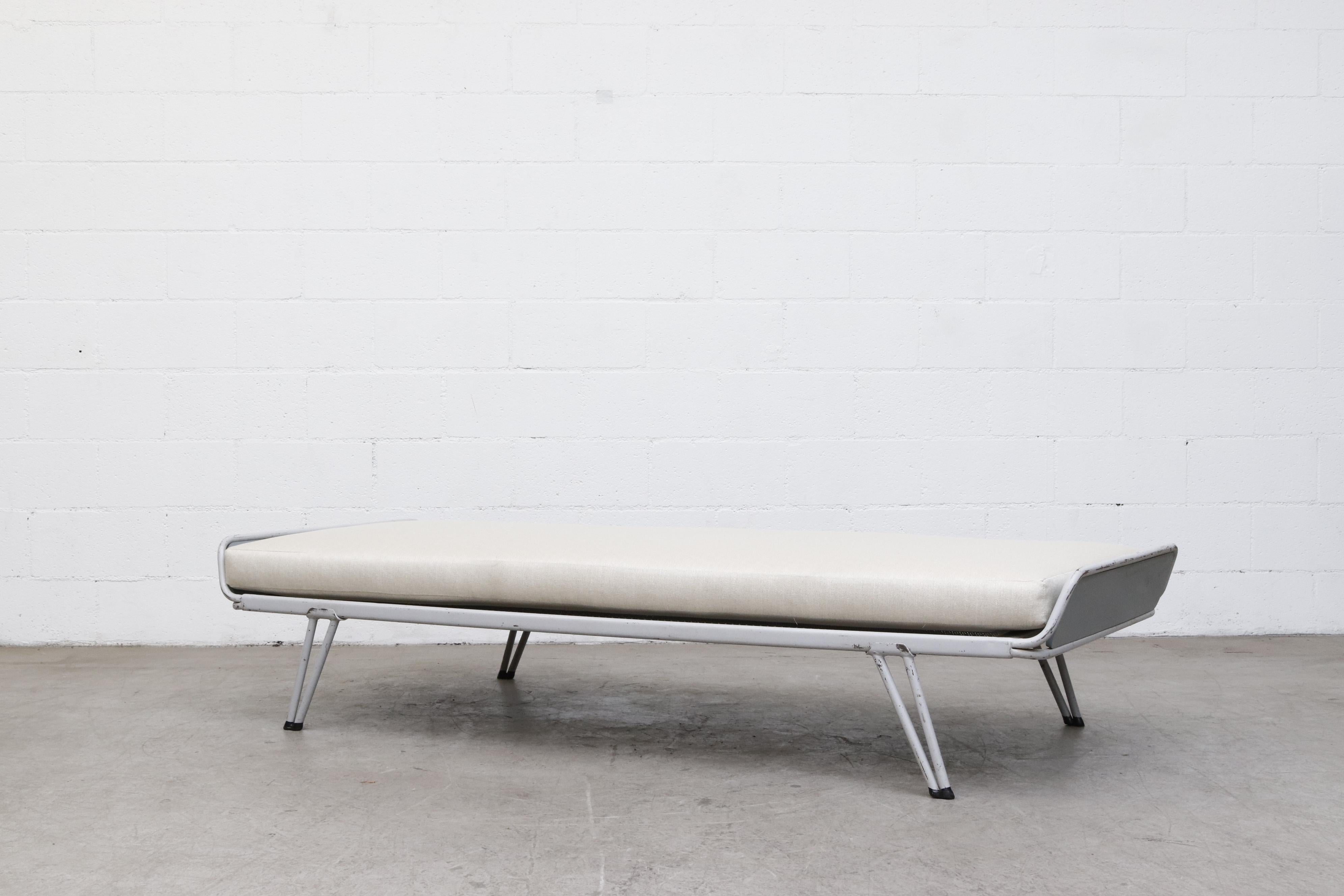 Newly upholstered industrial daybed by A.R. Cordemeyer for 'Auping'. Off-white mattress on a light grey enameled metal frame with signature 'Auping' Mesh support. In original condition with grey stained wood accents and visible frame wear and