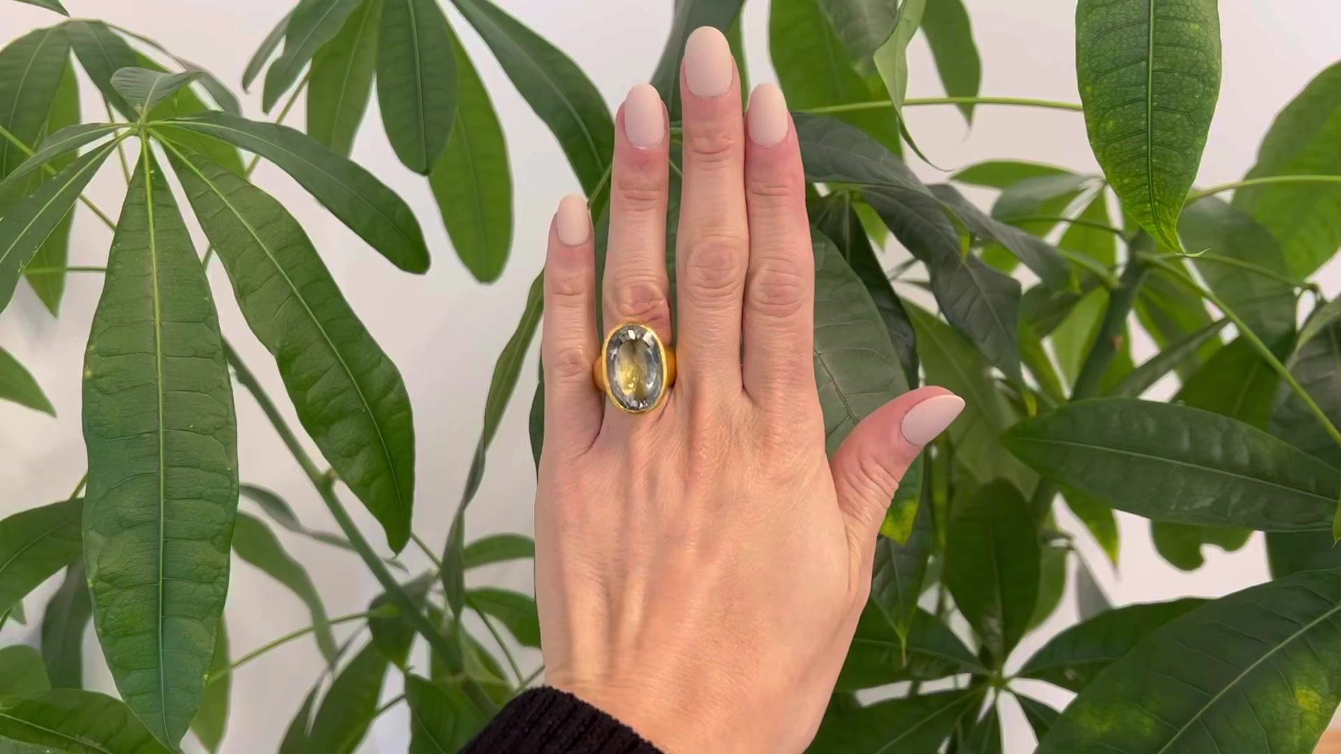 One ARA 17.00 Carat Aquamarine 24 Karat Yellow Gold Cocktail Ring. Featuring one oval cut aquamarine weighing approximately 17.00 carats. Crafted in 24 karat yellow gold signed ARA with purity marks. Circa 2010. The ring is a size 7 1/2 and may be