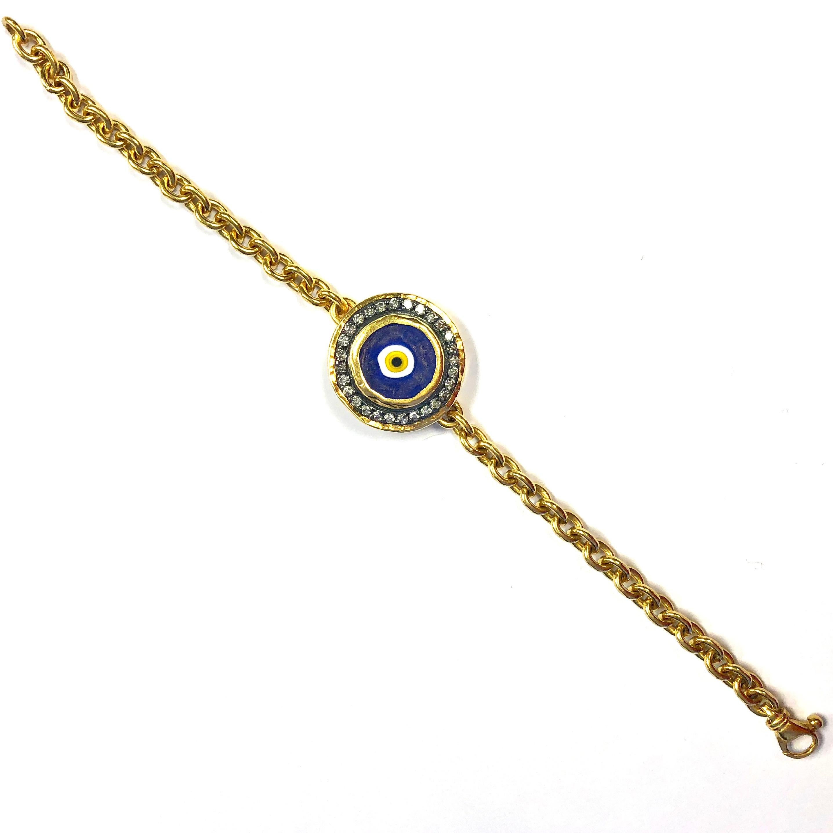 ARA dark blue evil eye and diamonds set in 24k gold and oxidized sterling silver center, supported by a 24k gold link bracelet. 
28 round brilliant cut diamonds, approximate total weight: 0.60 ct 
Weight: 23.1 grams
Length: 7.5 inches
Current retail