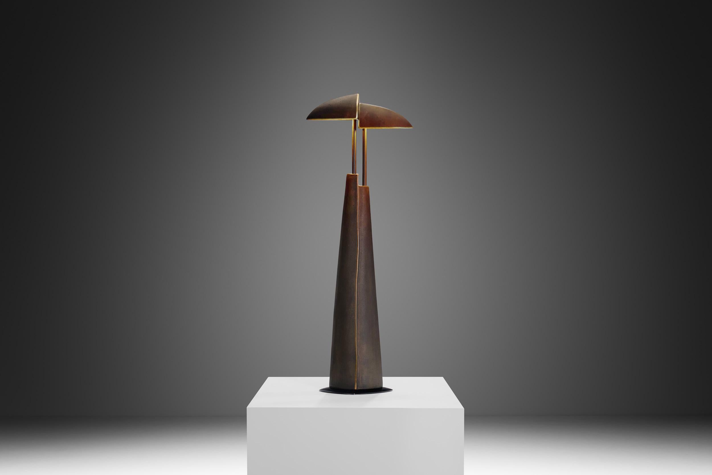 This heavy cast table lamp, designed by Annette van Gessel and Von Ullrich Mies, is a striking piece of late 20th century design. Utilitarian by design, the medium is forged with a simplicity of efficiency in mind, with just a glance towards design