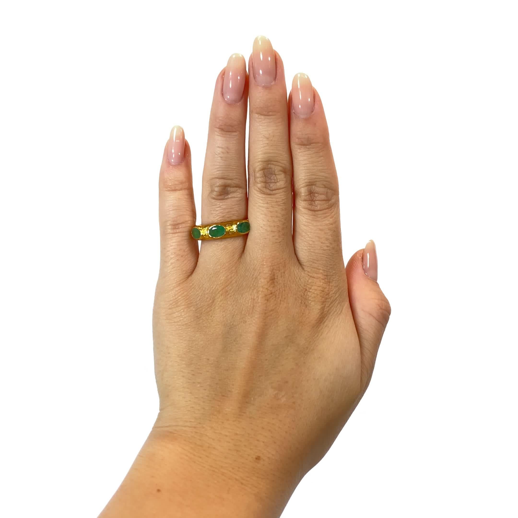 ARA24K Three Stone Emerald Textured 24 Karat Gold Band. The ring features 3 oval cut emeralds weighing approximately 1 carat. Circa 2000s. Size 7.

About The Piece: There is just something magical and joyful about these vibrant emeralds. Perfect for