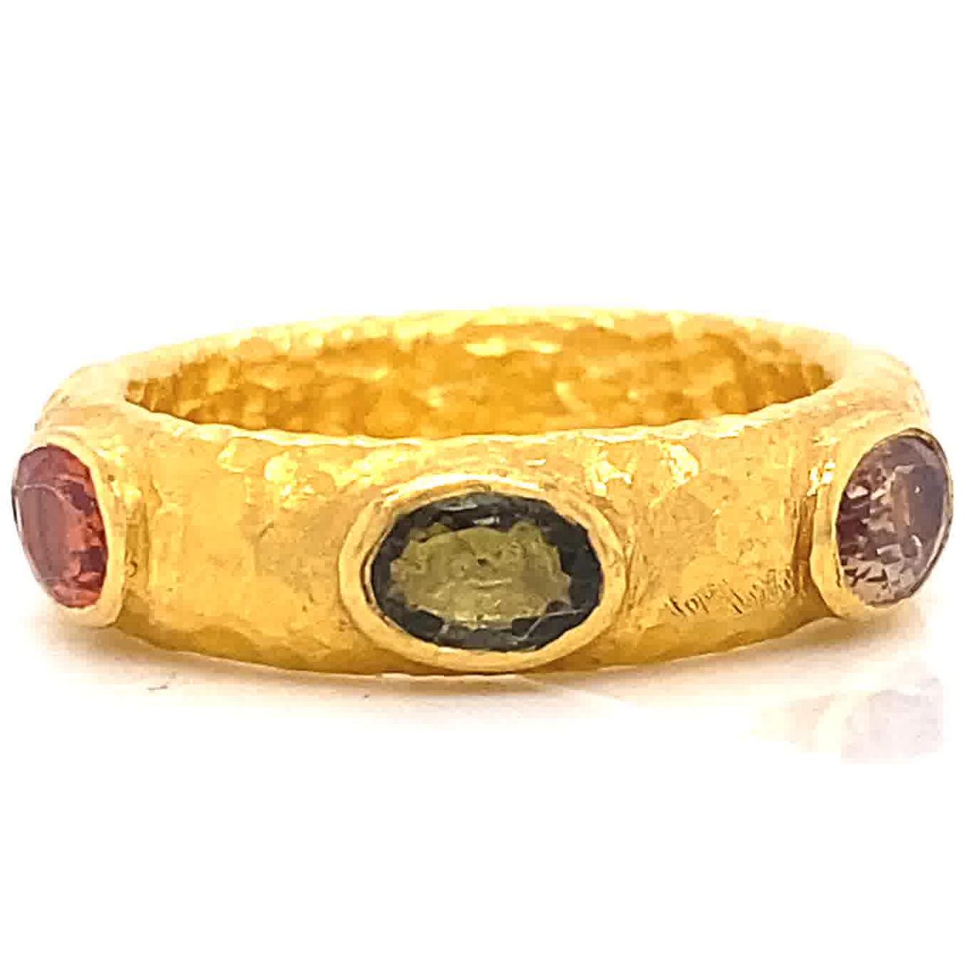 ARA985 Hand Made Sapphire 24 Karat Yellow Gold Textured Band. The ring features 6 sapphires approximately 0.30 carats each. Signed ARA 985 hand made. Circa 2000s. Size 7 1/4 and may be re-sized.

About The Piece: There is just something magical and