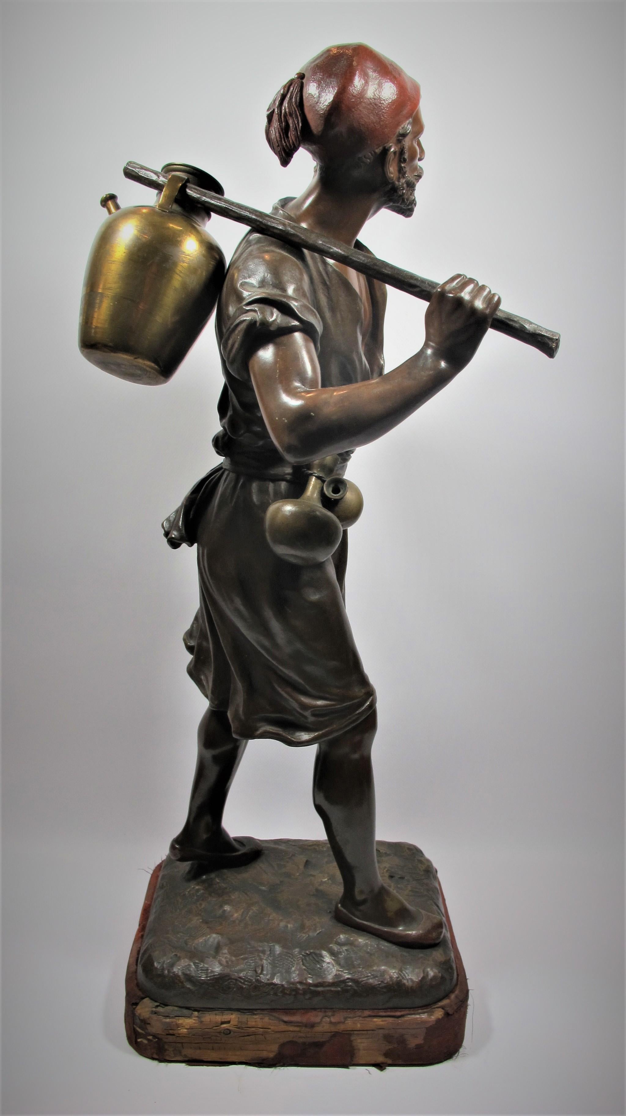 Bronze with polychrome patina representing an oriental water carrier, carrying a vase on the shoulder. Sculpture signed on the base Debut and bearing the seal of edition of the House Oudin. Natural base. 

Bibliography: Pierre Kjellberg, Les