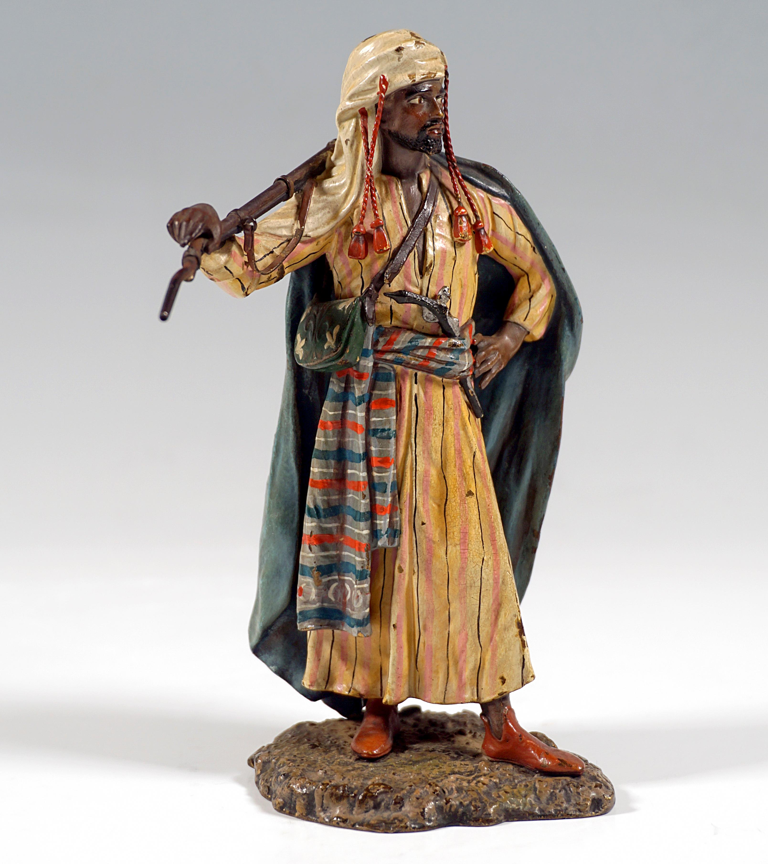 Excellent piece of Viennese bronze Art around 1900:
Arab in typical clothing of the desert peoples: ankle-length shirt with a cravat, a cloak, a scarf tied together as a head covering, a musket on his hip in the cravat, a rifle with bayonet