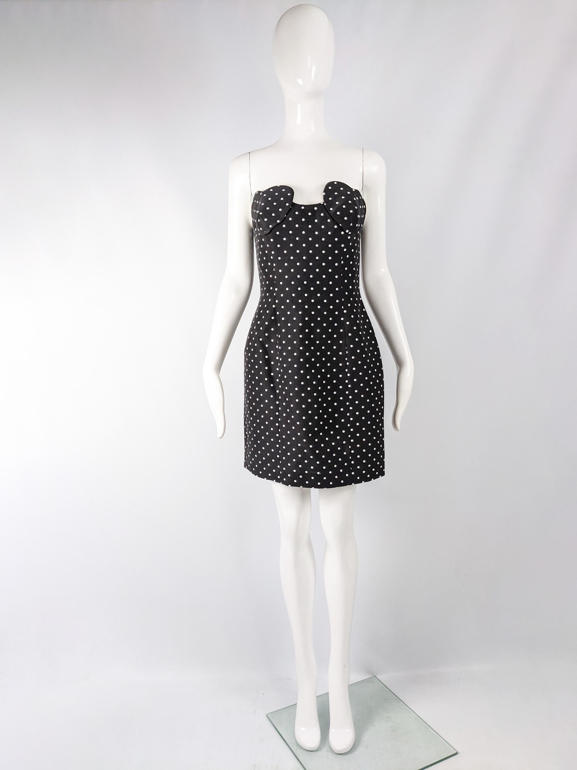 A cute and classic vintage dress from the 1980s by luxury British fashion designer Arabella pollen, one of Princess Diana's favourite designers. It is made from a black cotton blend with a pretty polka dot print throughout and an amazing sculptured