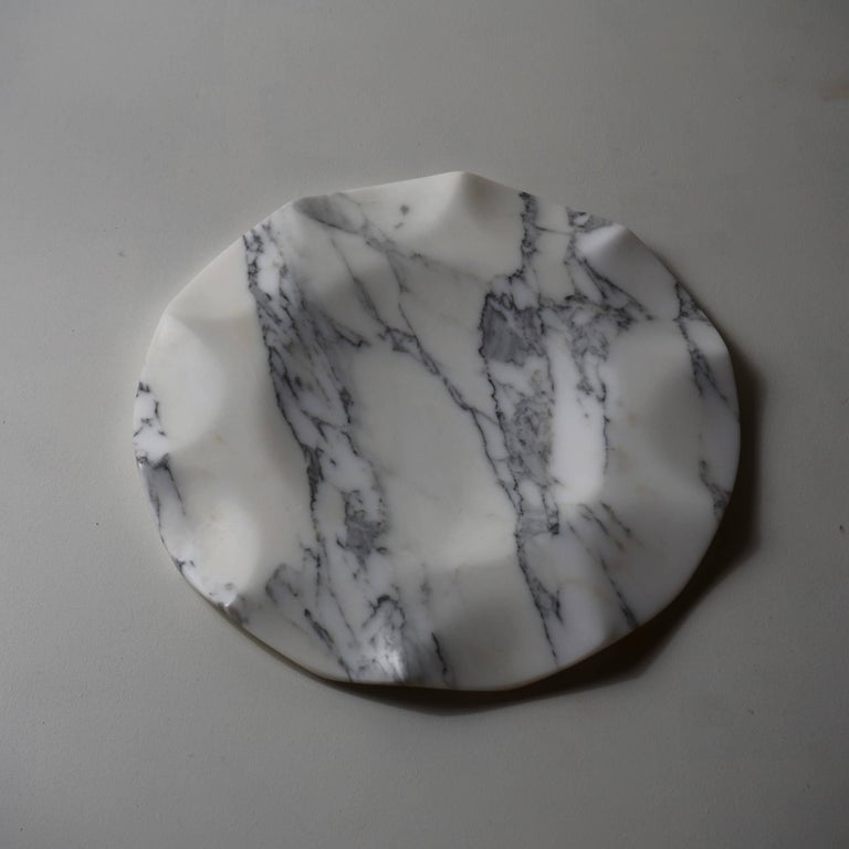 Centerpiece in Arabescato vagli marble.

The idea was to make the marble appear flexible and fluid to the eye and to the touch, to give the sensation that it was melting before our eyes, or that it was constantly changing. Like the ocean waves