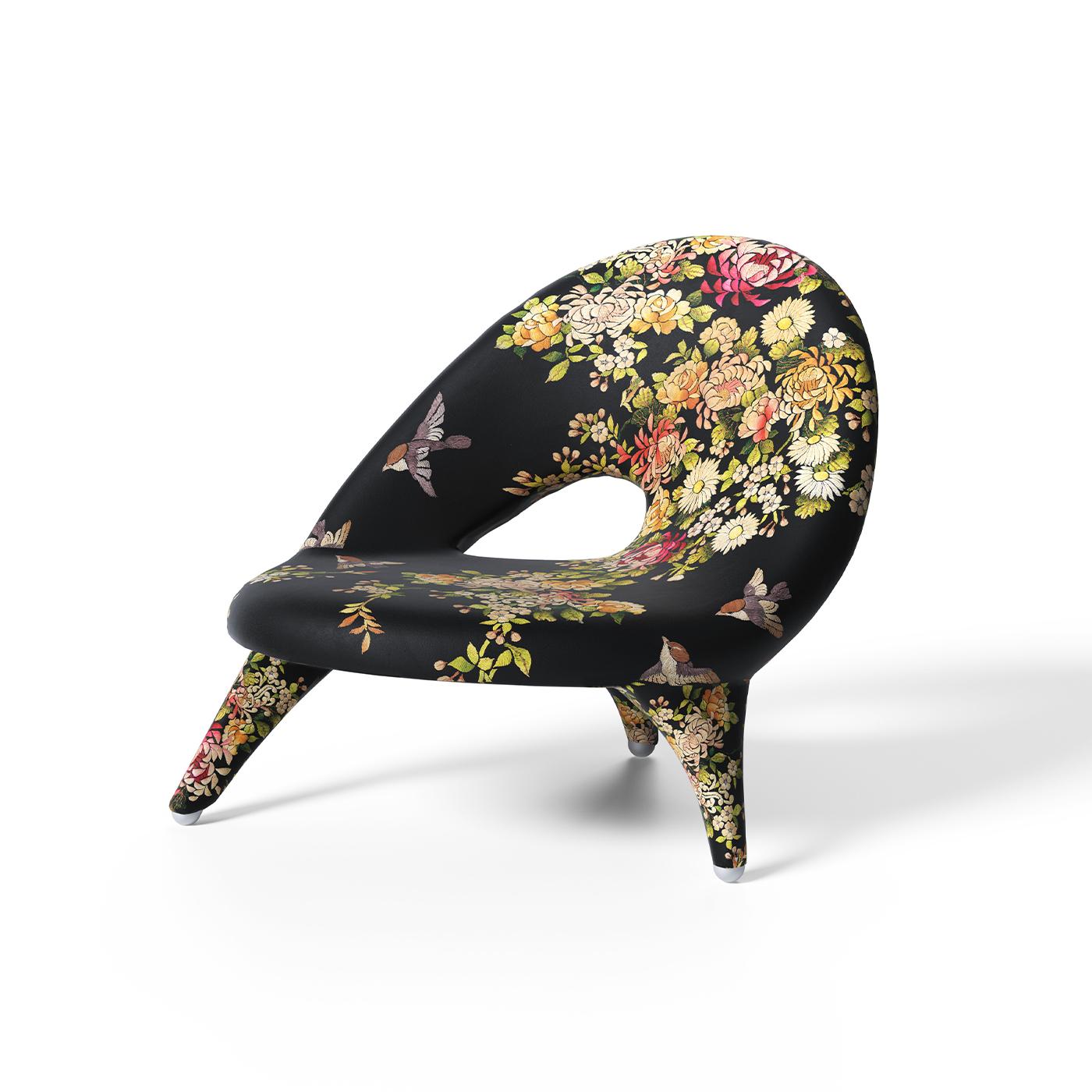 Three-legged armchair with structure in foam, upholstery in printed synthetic fabric “Tree of Life” by Simone Guidarelli on a black base. Silver lacquered-shaped wooden feet.
