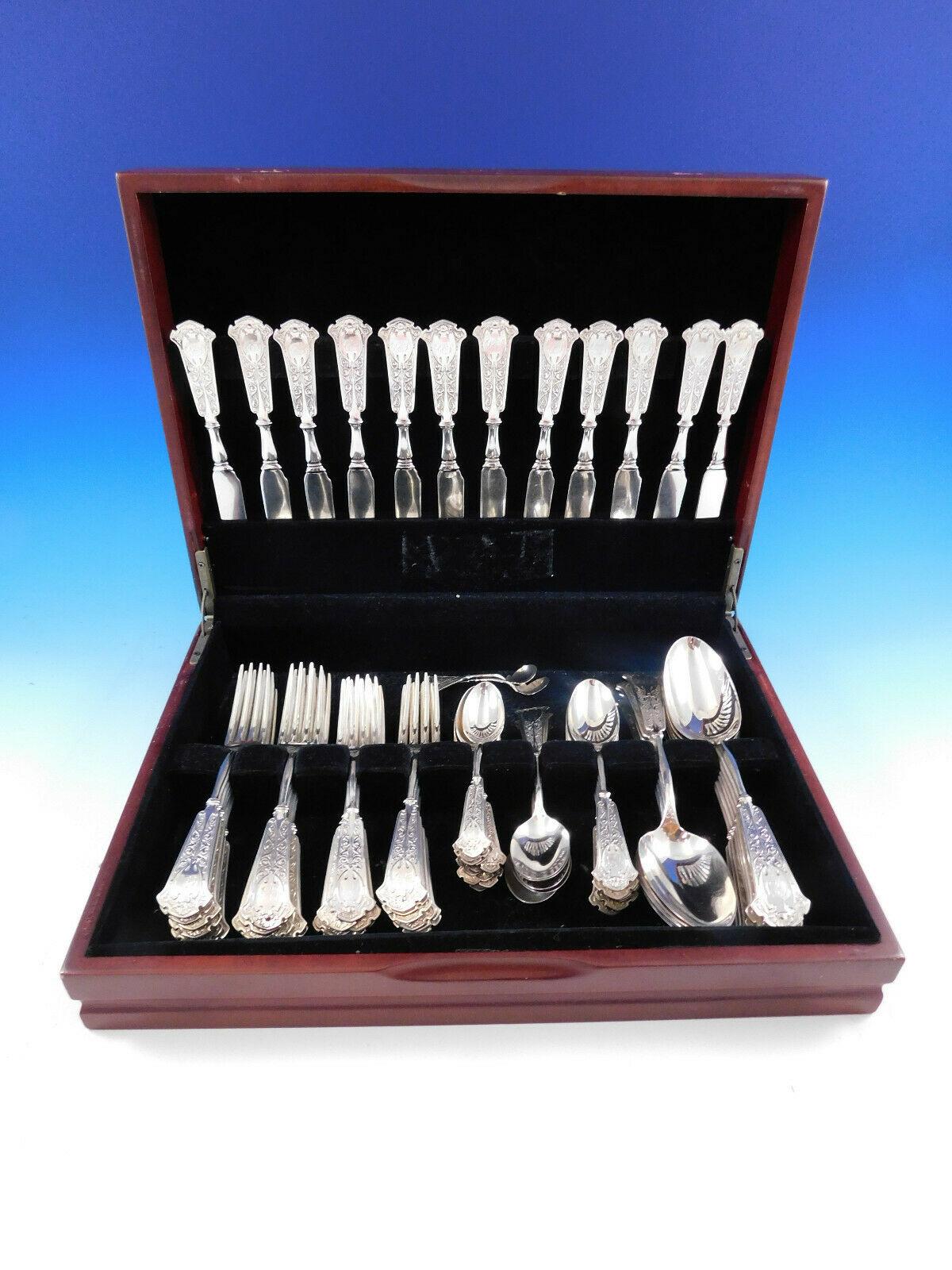 Exceedingly rare Moresque by Wendt sterling silver Flatware set - 74 pieces, circa 1873. This pattern features a dimensional gothic design on a textured background, with a central shield. This set includes:

12 Knives, flat handle all-sterling, 7