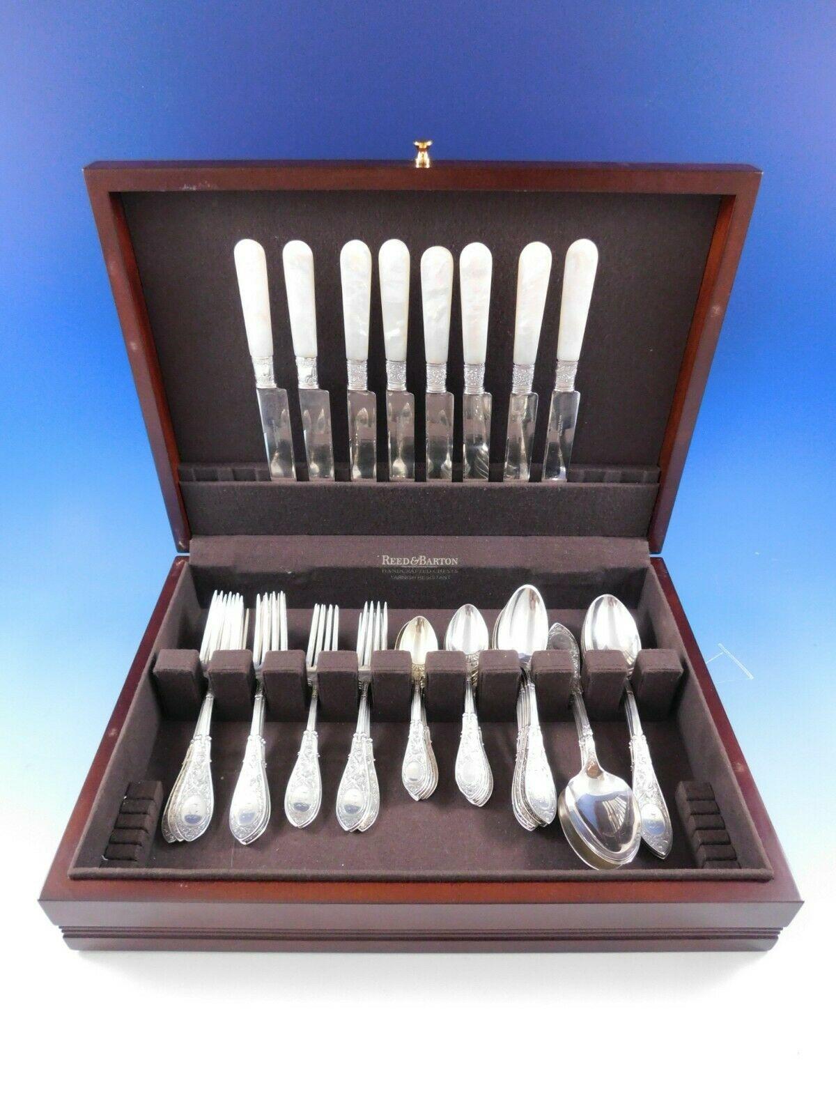 Arabesque by Whiting sterling silver flatware set - 56 pieces. This pattern was patented in the year 1875 and features a figural griffin. This set, like many early sterling flatware sets, includes Mother of Pearl Handle dinner knives . 

This set