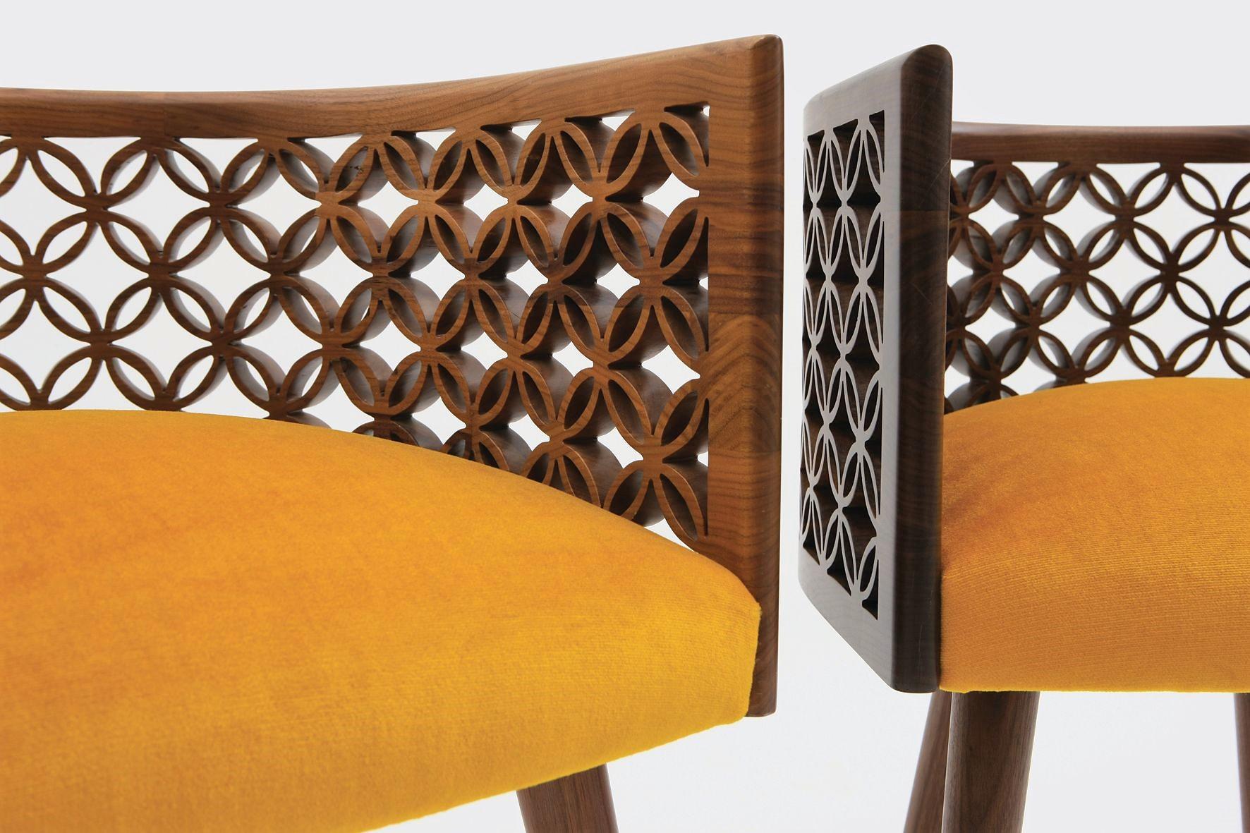 Nada Debs seating collection is reminiscent of mid-century design that marries modern form with exquisite craftsmanship. The Arabesque motif is finished in American walnut color. See photo for other velvet upholstery color options. 
The chair frame