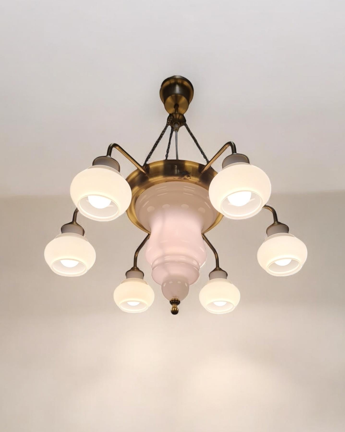 A truly stunning and rare 1001 Arabian Nights lantern styles chandelier with a modernistic touch made of brass and opaline glass. The lamp is made by Ker-Lux Mänttä and is most probably designed by Kai Ruokonen who was one of the few designers there