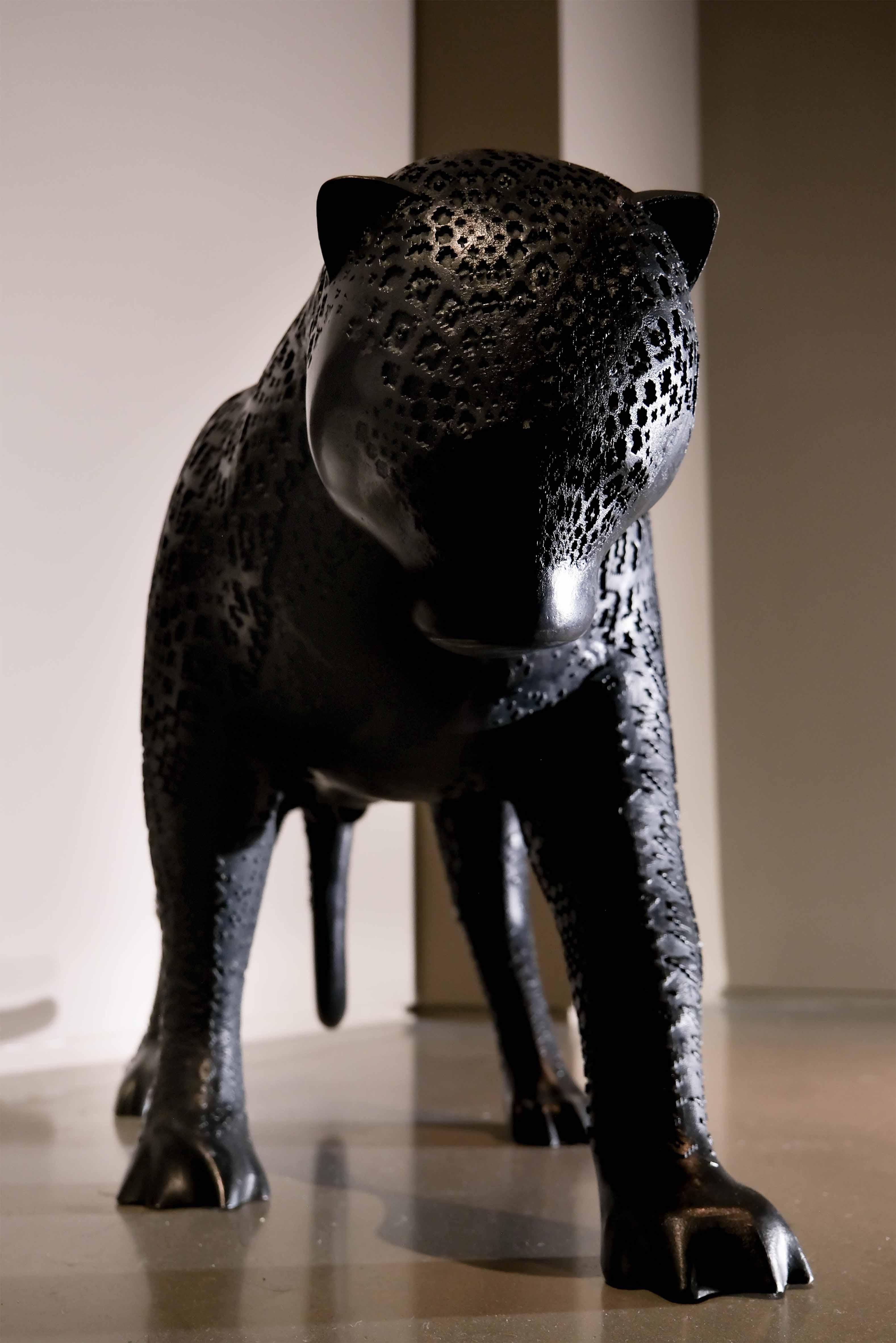 The Arabian Nights Jaguar by Hechizoo, a black cast bronze sculpture that captures the essence of power, grace, and mystique embodied by the enigmatic jaguar. This remarkable piece, cast in bronze with meticulous craftsmanship, stands as a testament