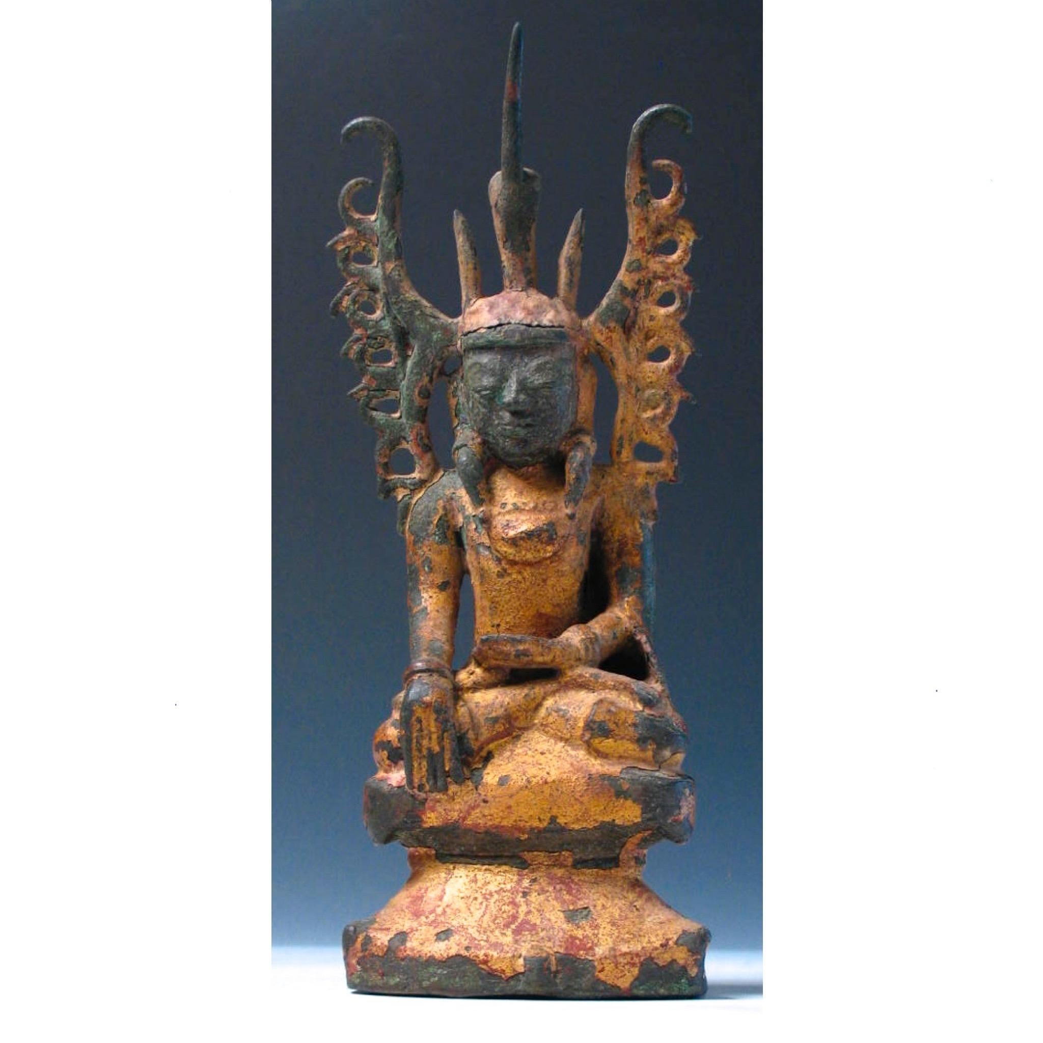 Arakanese Gilt Lacquered Bronze Mahakyain phara (Royal Oath) Buddha Image, a seated figure depicted in the bhumisparsa (earth touching) mudra, with small “fruit” in left hand, a majestic figure with elaborate crown, hairstyle and protruding