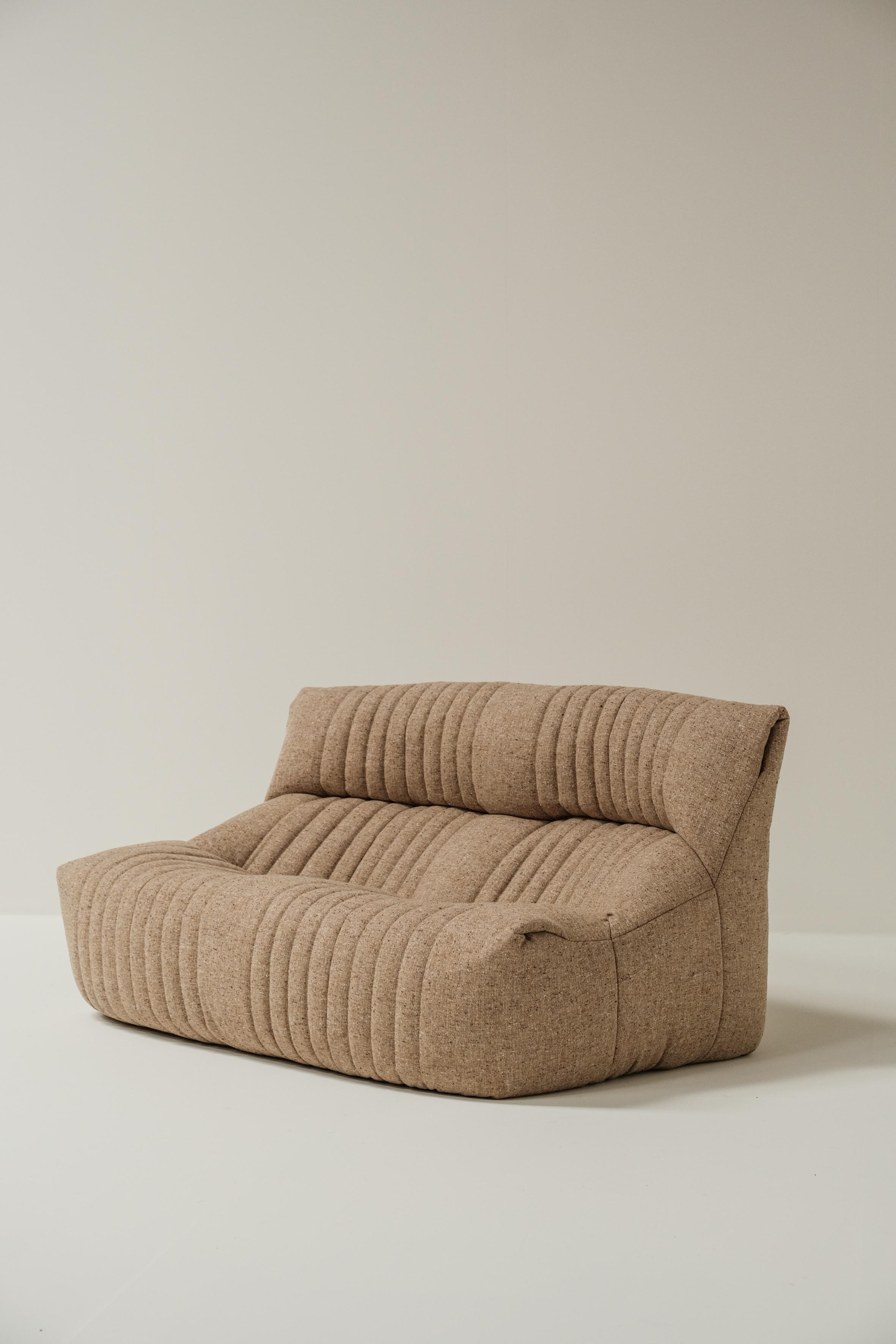This amazing design by Michel Ducaroy is one of the most comfortable designs he made. A slightly higher head rest than for example the famous togo sofa makes a big difference in comfort. 

The sofa is made out of foam and textile. The foam is still
