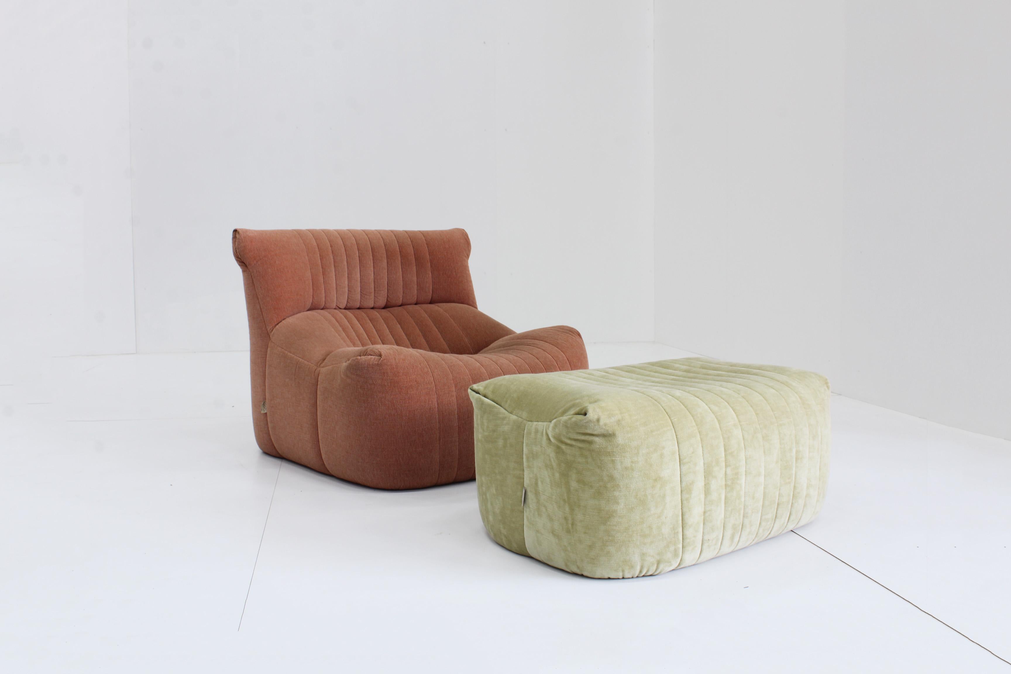 Aralia armchair and ottoman designed by Michel Ducaroy for Ligne Roset in the 1980s. This french design piece is in a good vintage condition. Colourful combination of the armchair and ottoman. Perfect to match with colors like brown, grey or yellow.