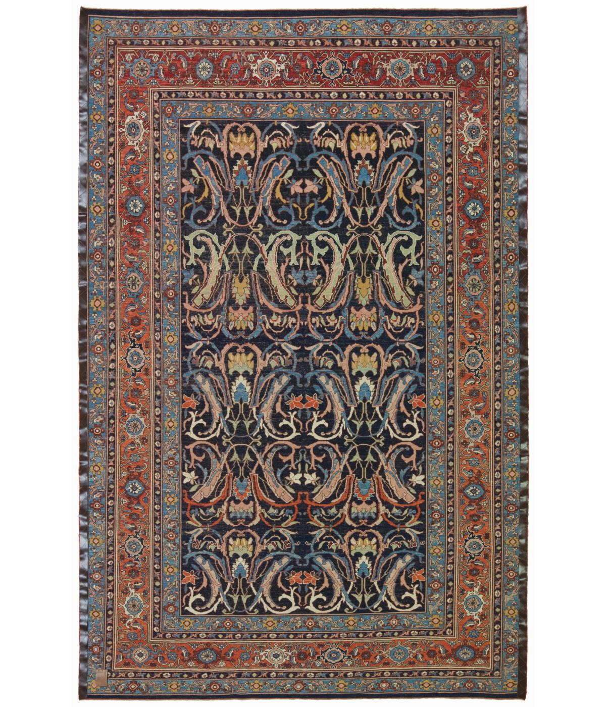 This is a repeat of large sweeping arabesques in muted colors adorning the midnight blue field rug designed in the early 20th century that originates from the Bidjar region in northwestern Iran. Bidjar rugs, in general, are renowned for their