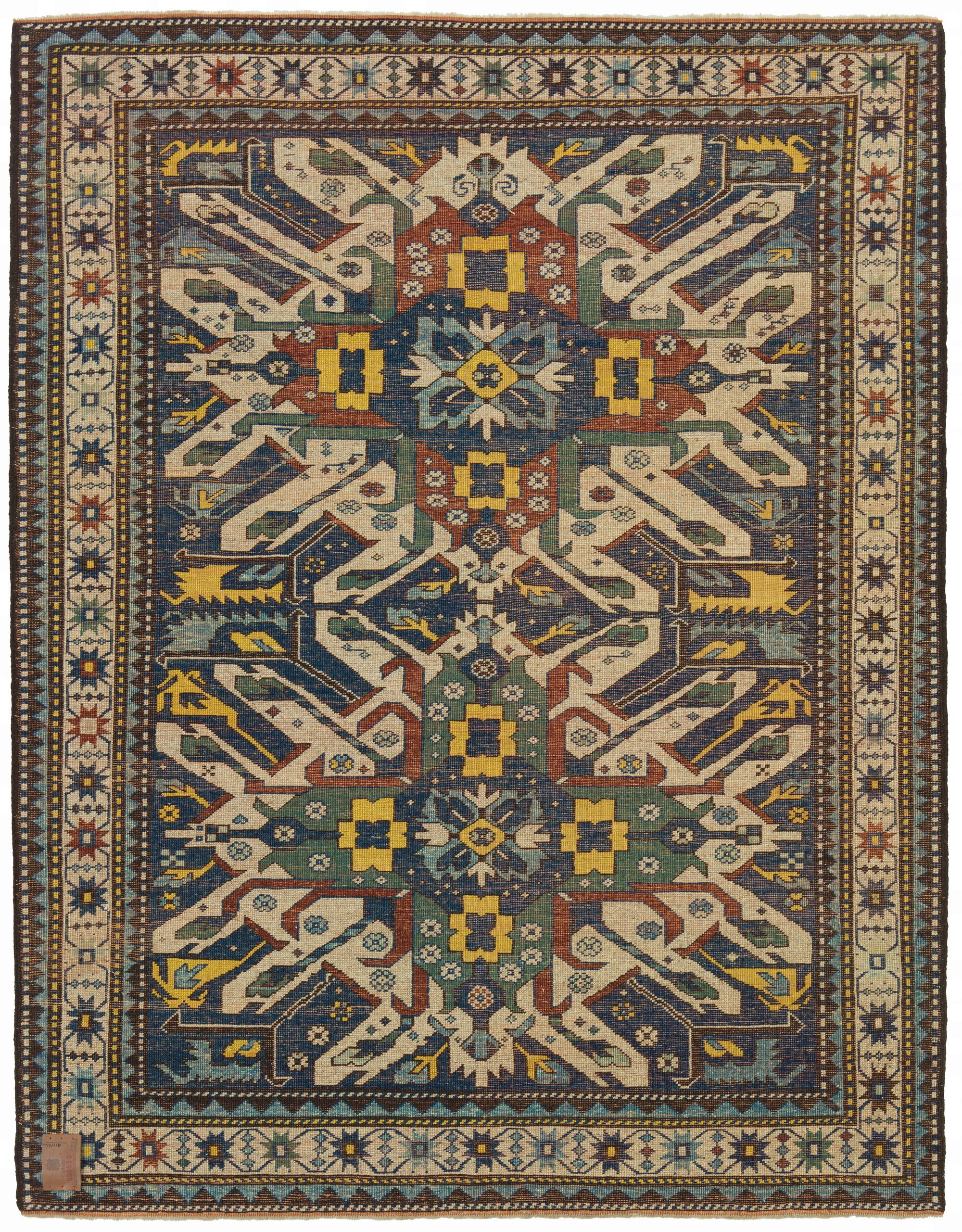The design source of the rug comes from the book Tapis du Caucase – Rugs of the Caucasus, Ian Bennett & Aziz Bassoul, The Nicholas Sursock Museum, Beirut, Lebanon 2003, nr.29 and Oriental Rugs Volume 1 Caucasian, Ian Bennett, Oriental Textile Press,