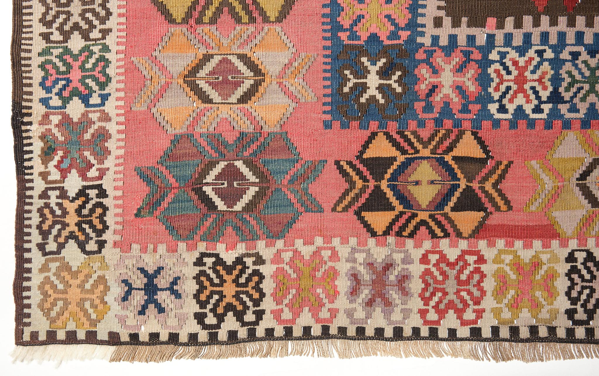 This is an Eastern Anatolian Antique Kilim from the Bayburt region with a rare and beautiful color composition.

The deep green in the central field is particularly impressive and rare, and the combination of blue, pink, red, and countless other