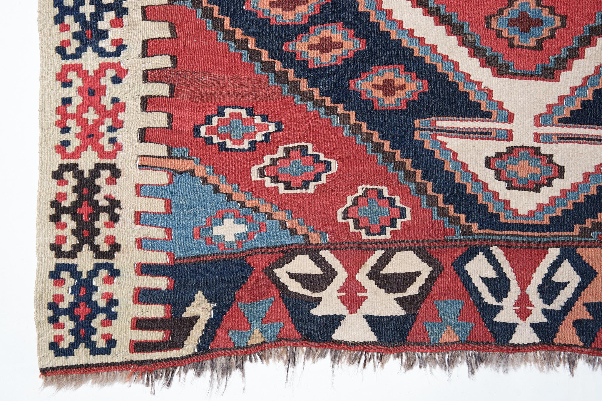 This is a Southern Anatolian Antique Rashwan Kilim from the Malatya region with a rare and beautiful color composition.

It is a large, 4 meters long Kilim with two halves attached and fits almost perfectly. The beauty of the dyed color is a