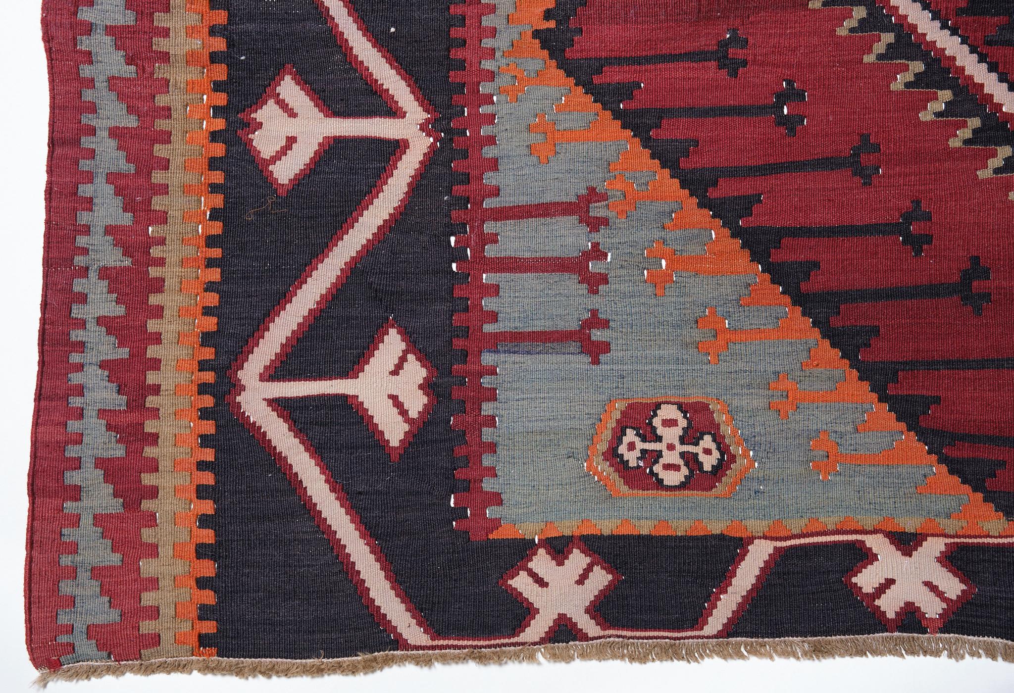 This is a large, Caucasian Old Kilim from the Kuba region with a red background and beautiful color composition.

The large, continuous medallions with zigzag patterns have an impact. Both the left and right borders and the pattern on the inner