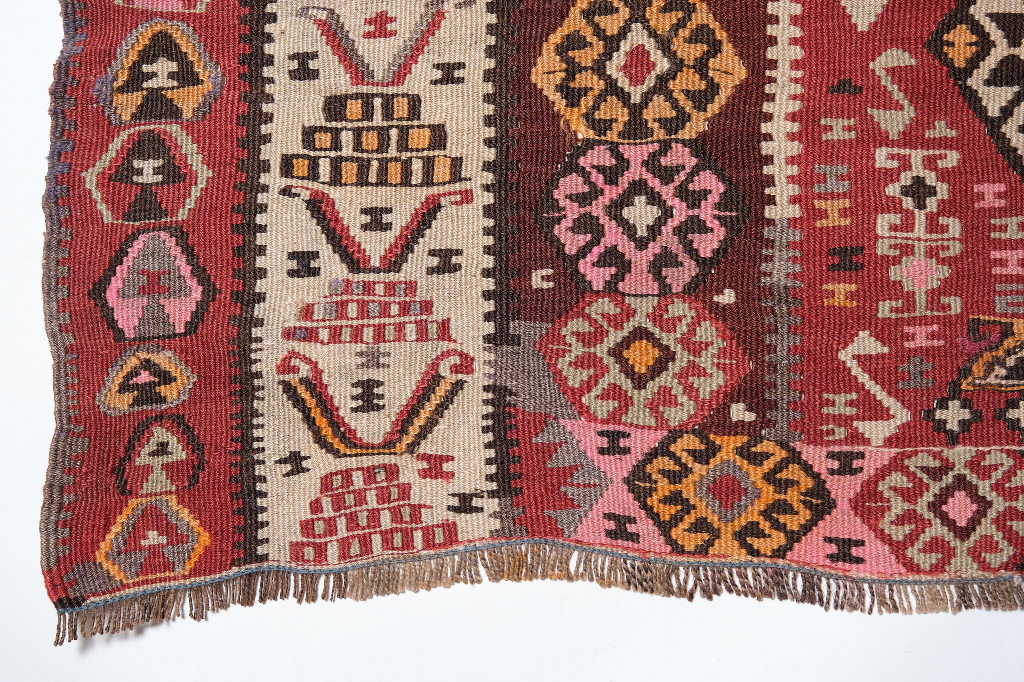 This is an Eastern Anatolian Vintage Old Kilim from the Erzurum region with a rare and beautiful color composition.

Erzurum was once a key frontier town, used to defend Anatolia against many invasions, and was also an important point on the