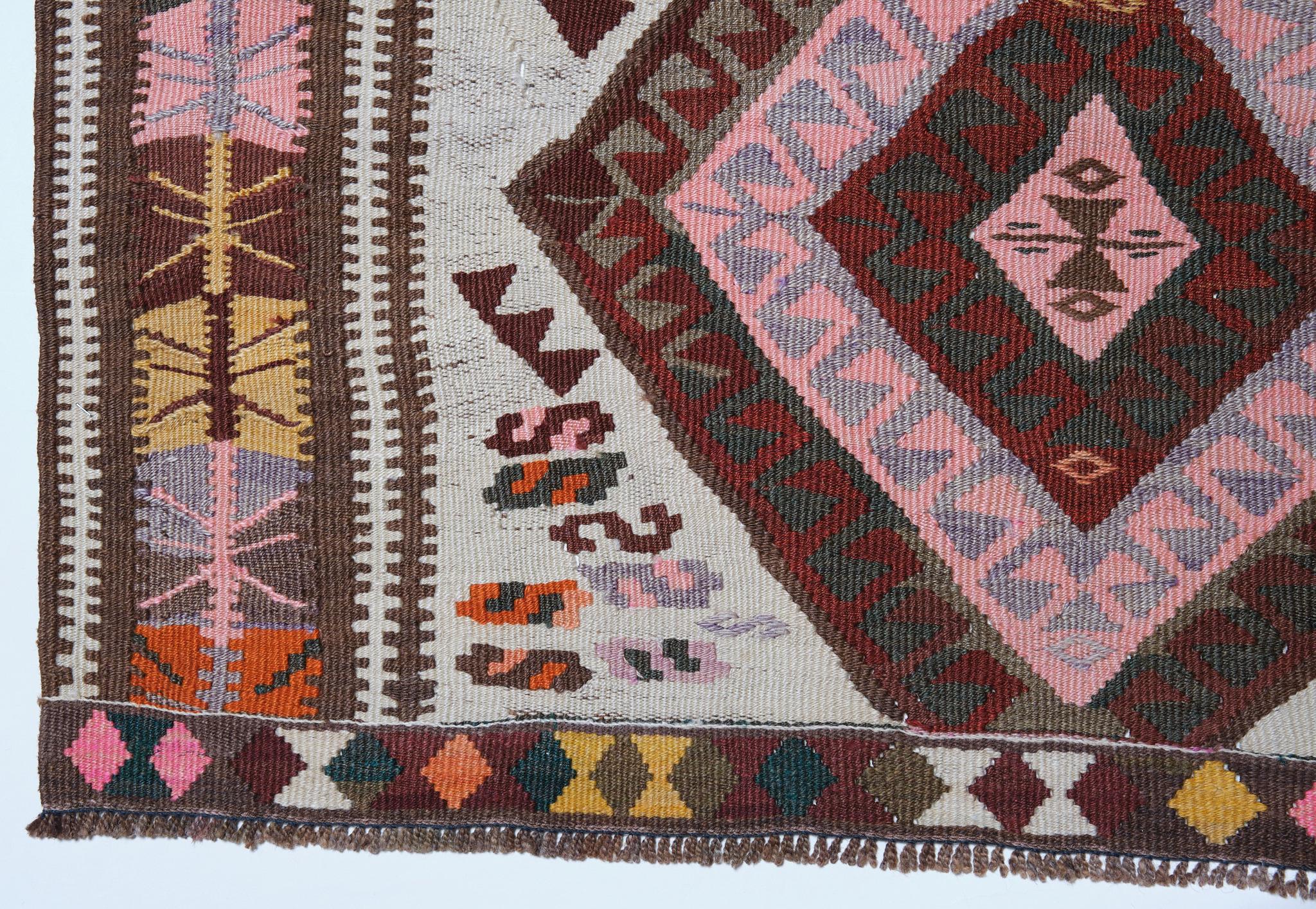 This is an Eastern Anatolian Vintage Kilim from the Kars region with a rare and beautiful color composition.

The old sector and newer southern districts of Kars are joined by a bridge built by the Seljuk Turks over the Kars Cayi River. The town