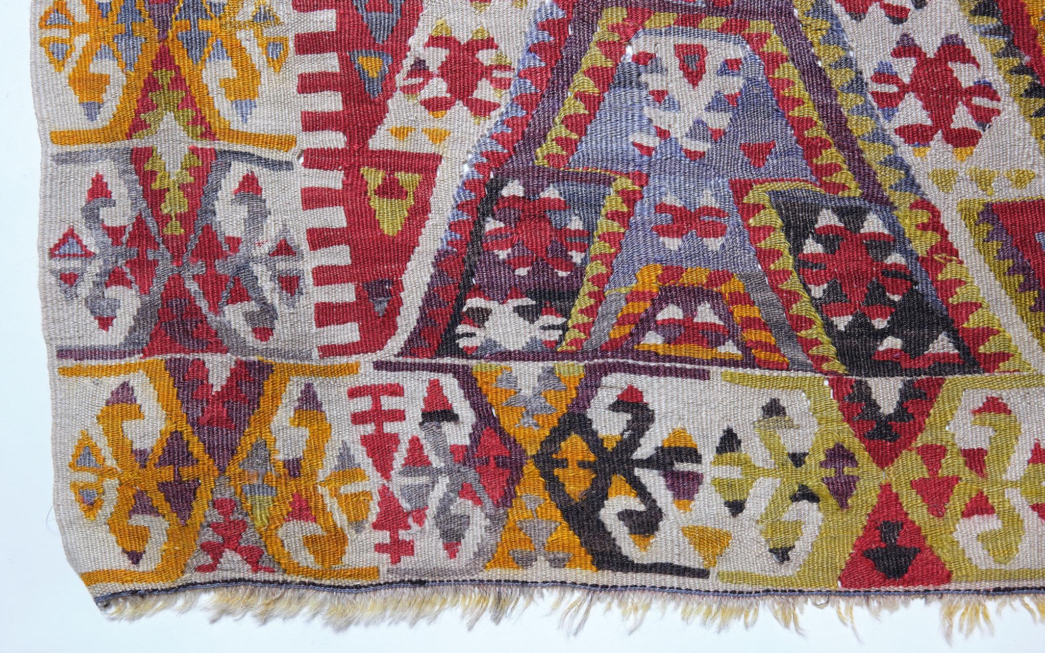 This is a South Eastern Anatolian old vintage Kilim from the Malatya region with a rare and beautiful color composition.

Malatya is Turkey's main kilim production area, and there are many variations. This is one of them, a runner-type kilim. The