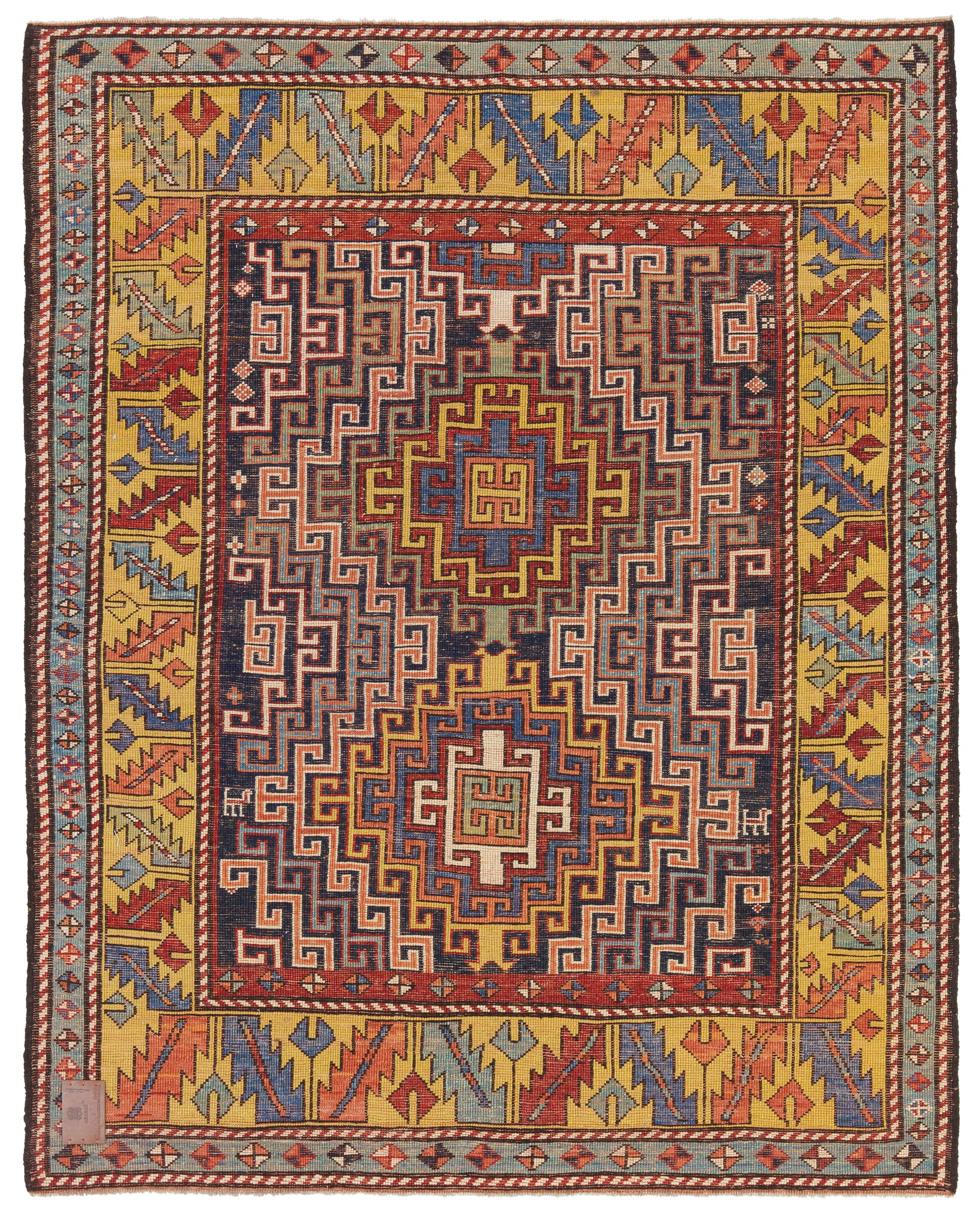 This is a complete hooked field with double medallions rug from the late 19th century, Kazak region, Caucasus area. A striking field design features two medallions each with concentric hook motifs, with a double latch-hooks design in the center of
