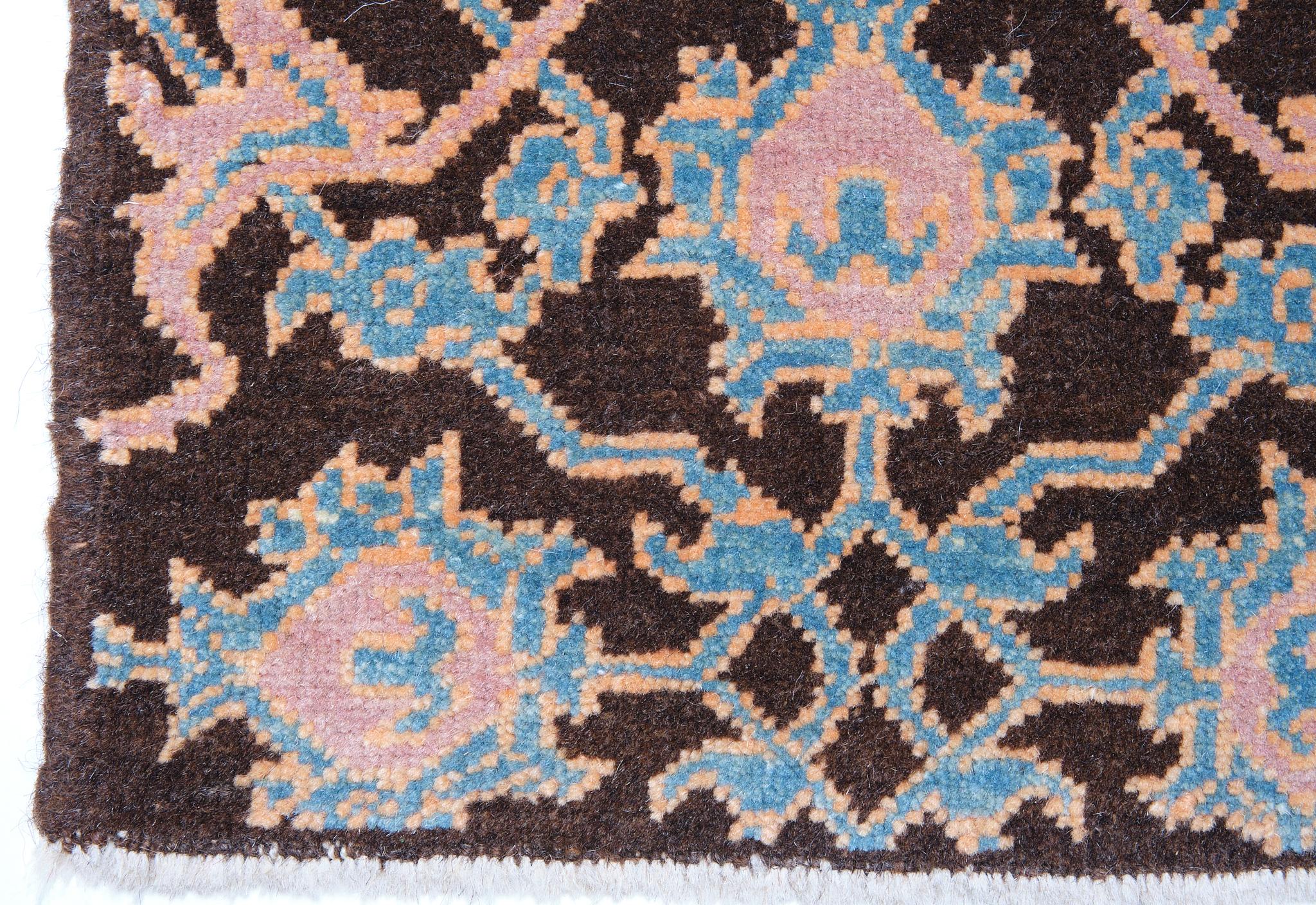 This rug has an interpreted design composed of a palmette lattice pattern taken from a part of the Mamluk rug, filling the field elegantly. These kinds of rugs have often been described as wagirehs or samplers and were said to have been used as