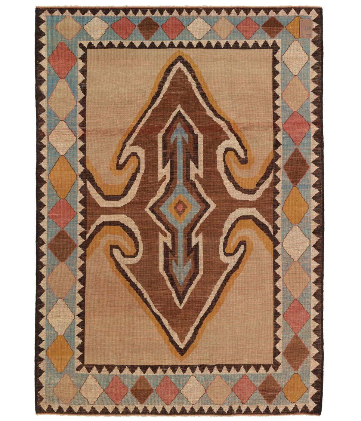 This Gabbeh rug, designed in the 1930s, is a type of handwoven rug that originated from Iran, specifically from the southwestern region known as Fars. The word 
