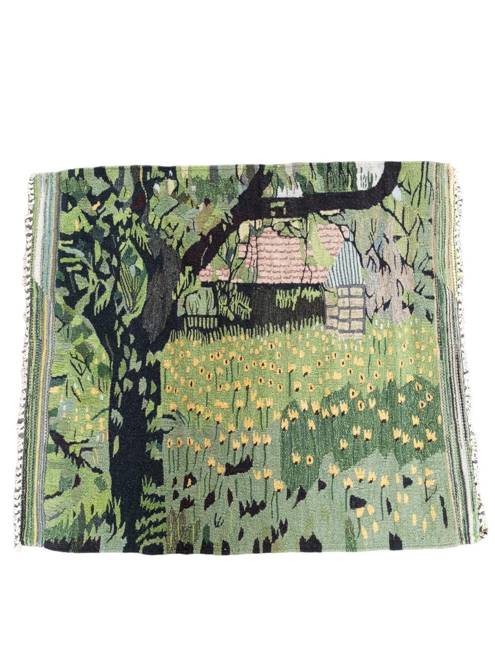 This  tapestry measuring 94 cm. x 82 cm. is handmade,  in wool. An enchanting landscape stands out: in the center of the scene is a small, red-roofed country house, a symbol of welcome and warmth. In Front  stands a tree with leaves embroidered in