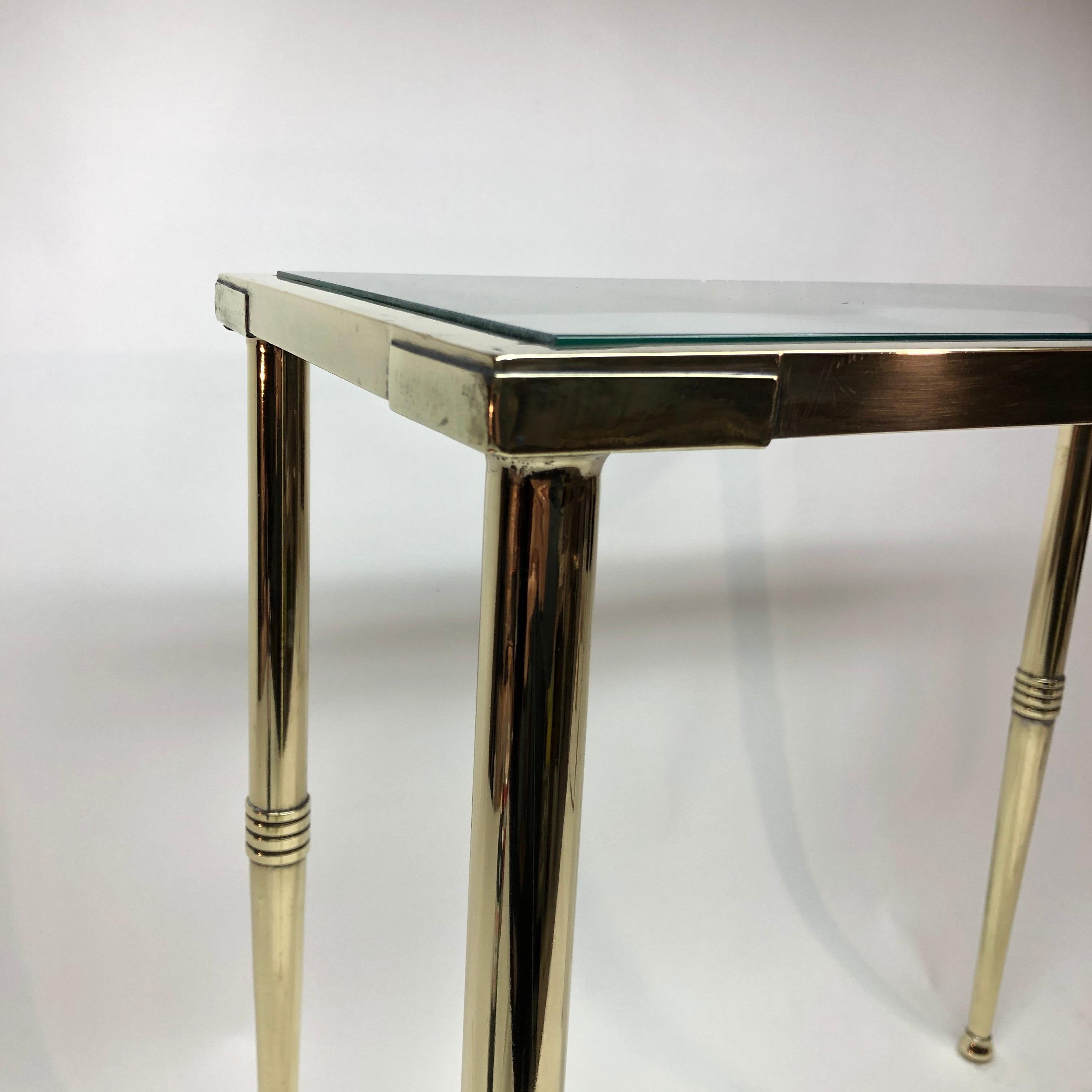 Brass occasional table with a glass insert top in the style of Andre Arbus.
