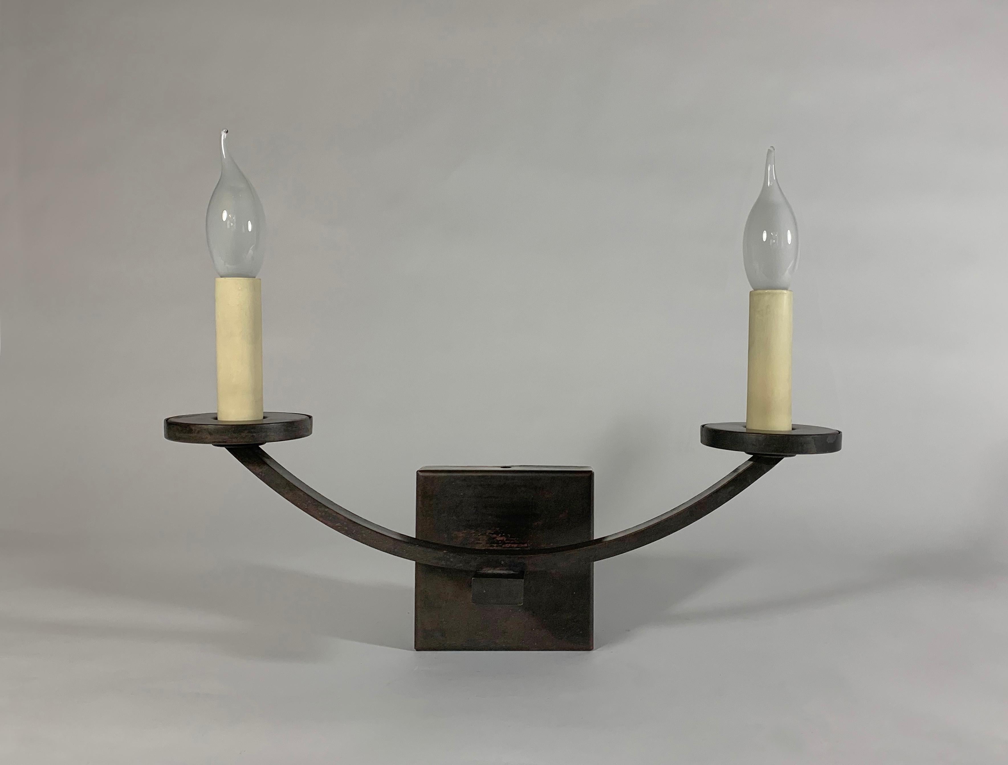 A traditional 2-candle brass wall light with rustic bronze finish and card candles. Candelabra bulb holders.
Original prototype.