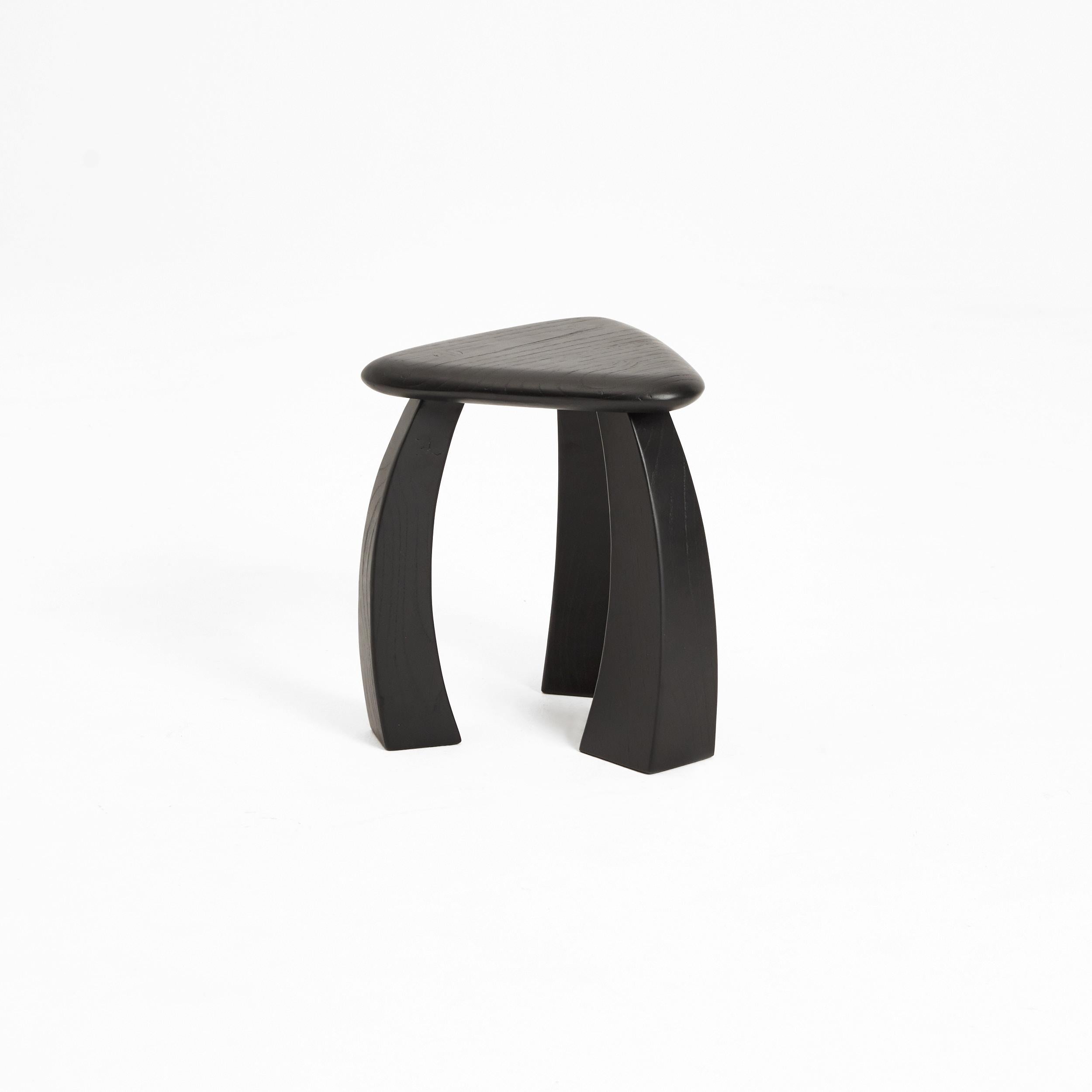 Arc de Stool '37 in black painted Chestnut Wood

Designed by Project 213A in 2022

The smaller version of the stool's legs curves inwards towards its triangular seat, fusing to showcase exquisite craftsmanship. The elegant complexion brings