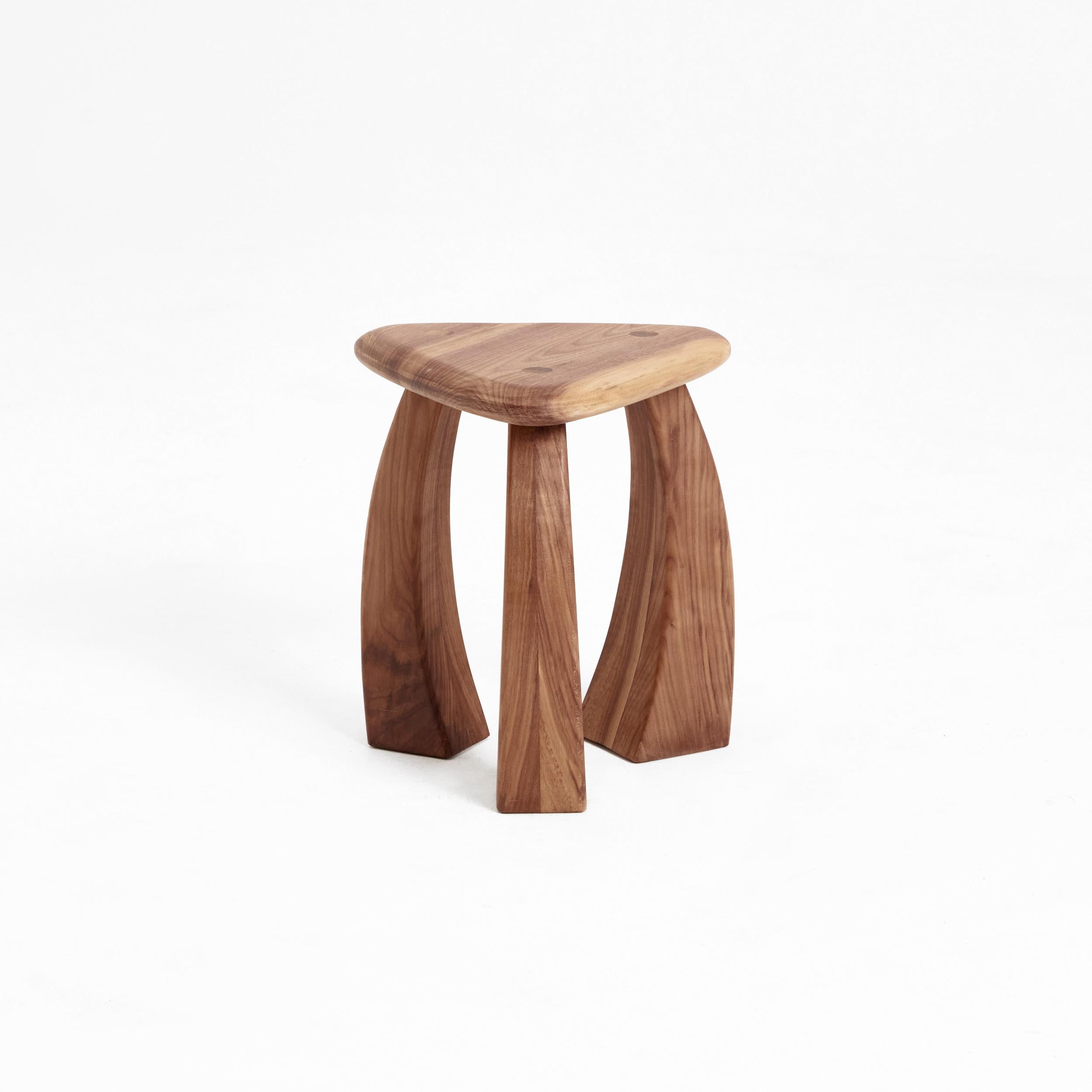 Arc de stool 37 in natural walnut by Project 213A
Dimensions: D 33 x W 33 x H 37 cm
Materials: Walnut wood. 

The smaller version of the stool's legs curves inwards towards its triangular seat, fusing to showcase exquisite craftsmanship. The
