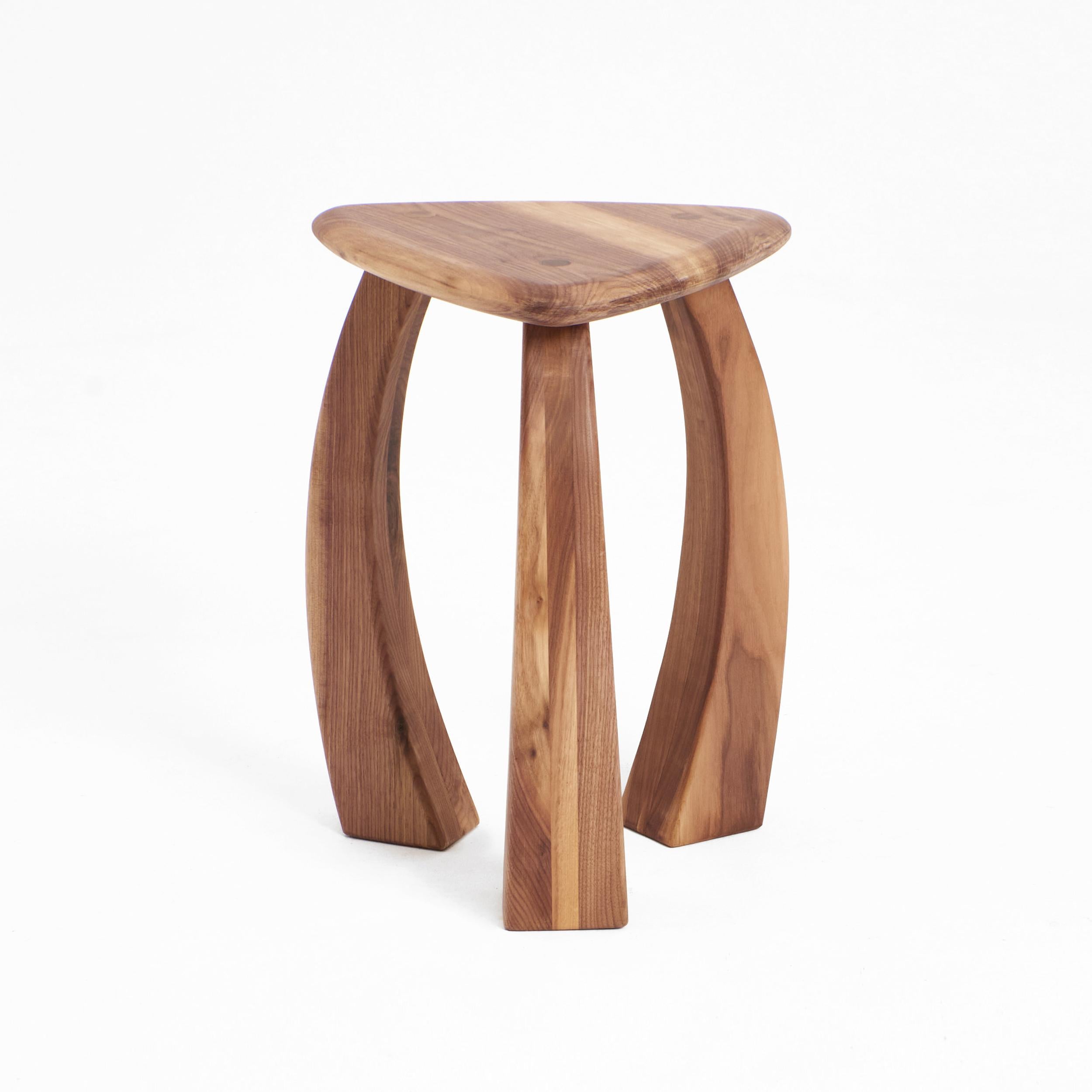 Arc de stool 52 in Walnut by Project 213A
Dimensions: D 39 x W 39 x H 52 cm
Materials: Walnut wood. 

The taller version of the stool's legs curves inwards towards its triangular seat, fusing to showcase exquisite craftsmanship. The elegant