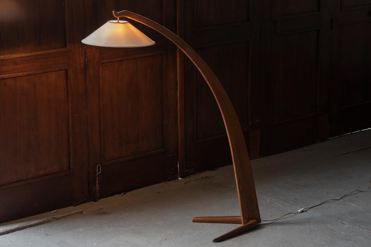 Gracious arc floor lamp designed in Italy during the 1950s. This modernist lamp resembles the one made by Studio BBPR. It is made from solid elm wood and has a fabric shade with an embroidered rim. In good condition, as shown in the pictures.