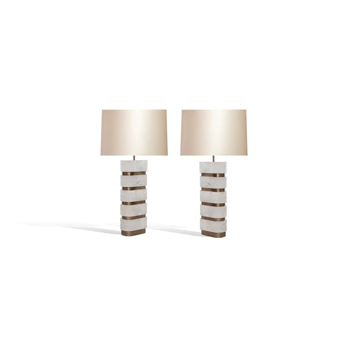 Pair of arc-shaped block form rock crystal quartz lamps with antique brass insert decoration. Created by Phoenix Gallery, NYC.
Each lamp installed with two sockets, 75 watts each socket, total of 150-watt maximum.
(Lampshade not included).