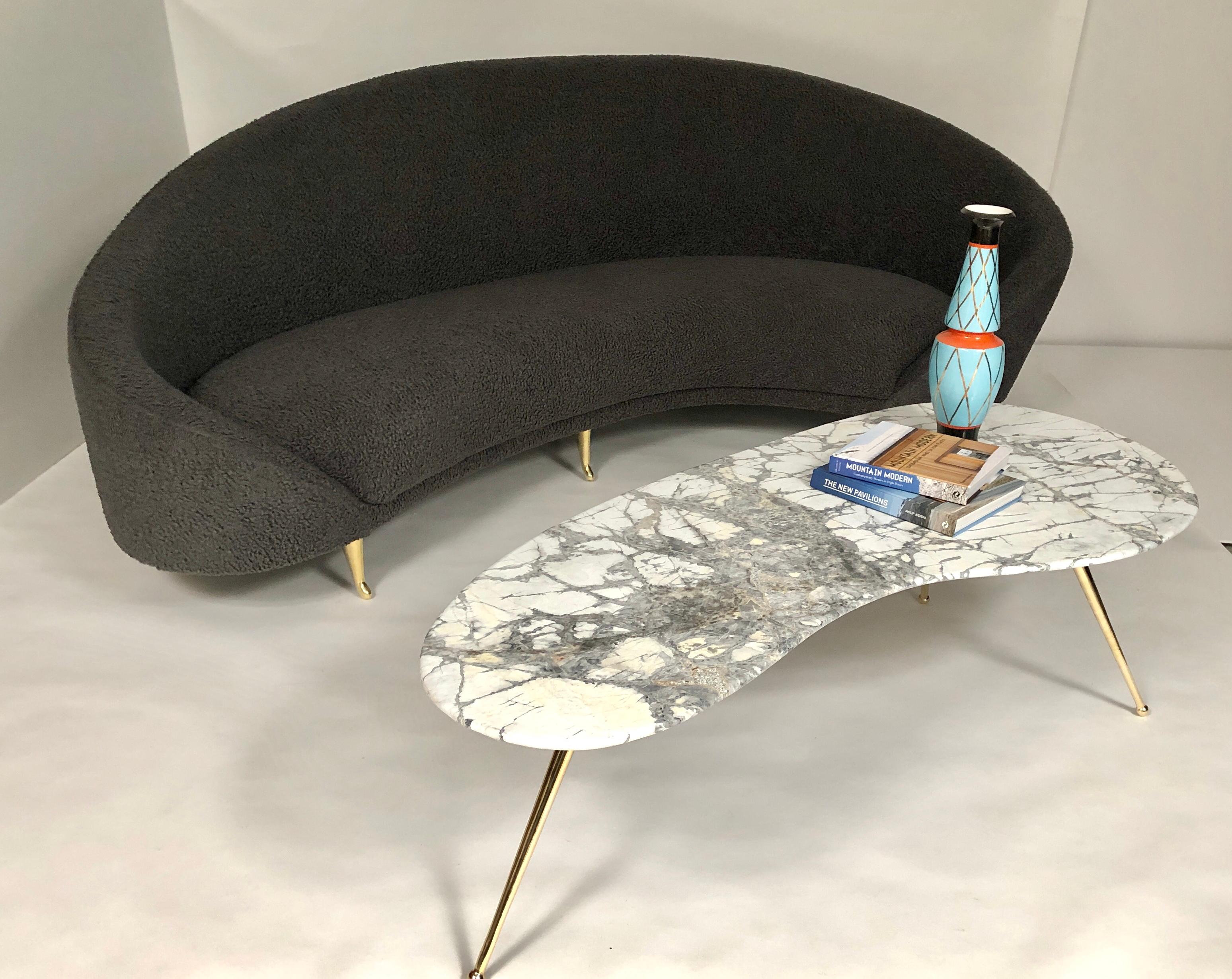 This chic sofa, reminiscent of the 1960’s, has elegant lines with gracious curves. The brass feet add to its sophistication with their delicate design. It will be the focal
point of any room. The kidney shape of the sofa provides plenty of