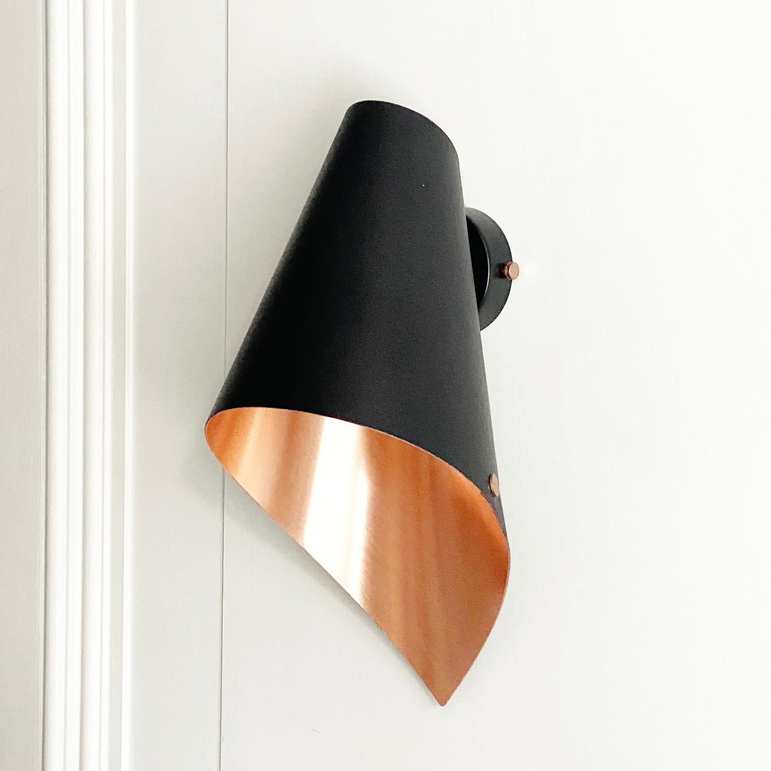 This beautiful brushed copper & matte black wall light is from our debut British lighting range.

Our contemporary wall lights are perfect for bathing your home in beautiful light, maybe above your favourite chair or beside your bedside for