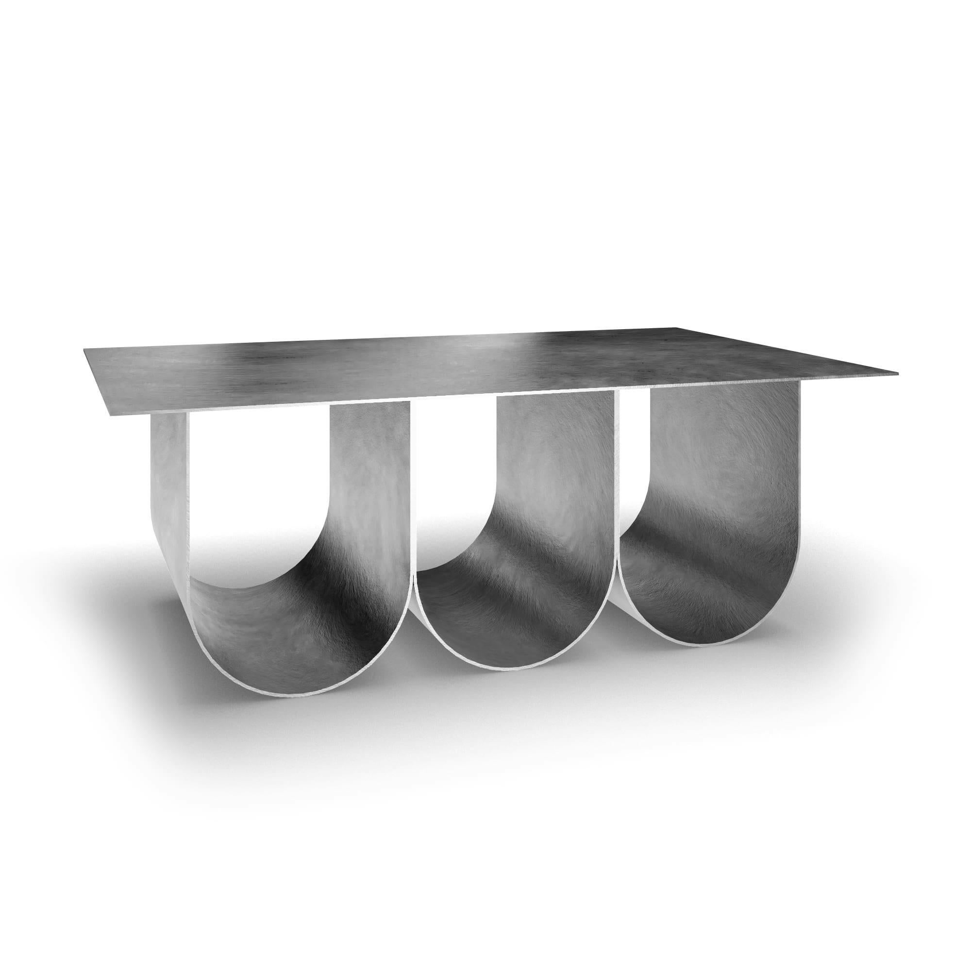 The Arcade coffee table - Square stainless steel natural color version has been created By Kasadamo in collaboration with Pierre Tassin, french designer. This table reflects a mix between old and futuristic architecture. Its identity is found in the