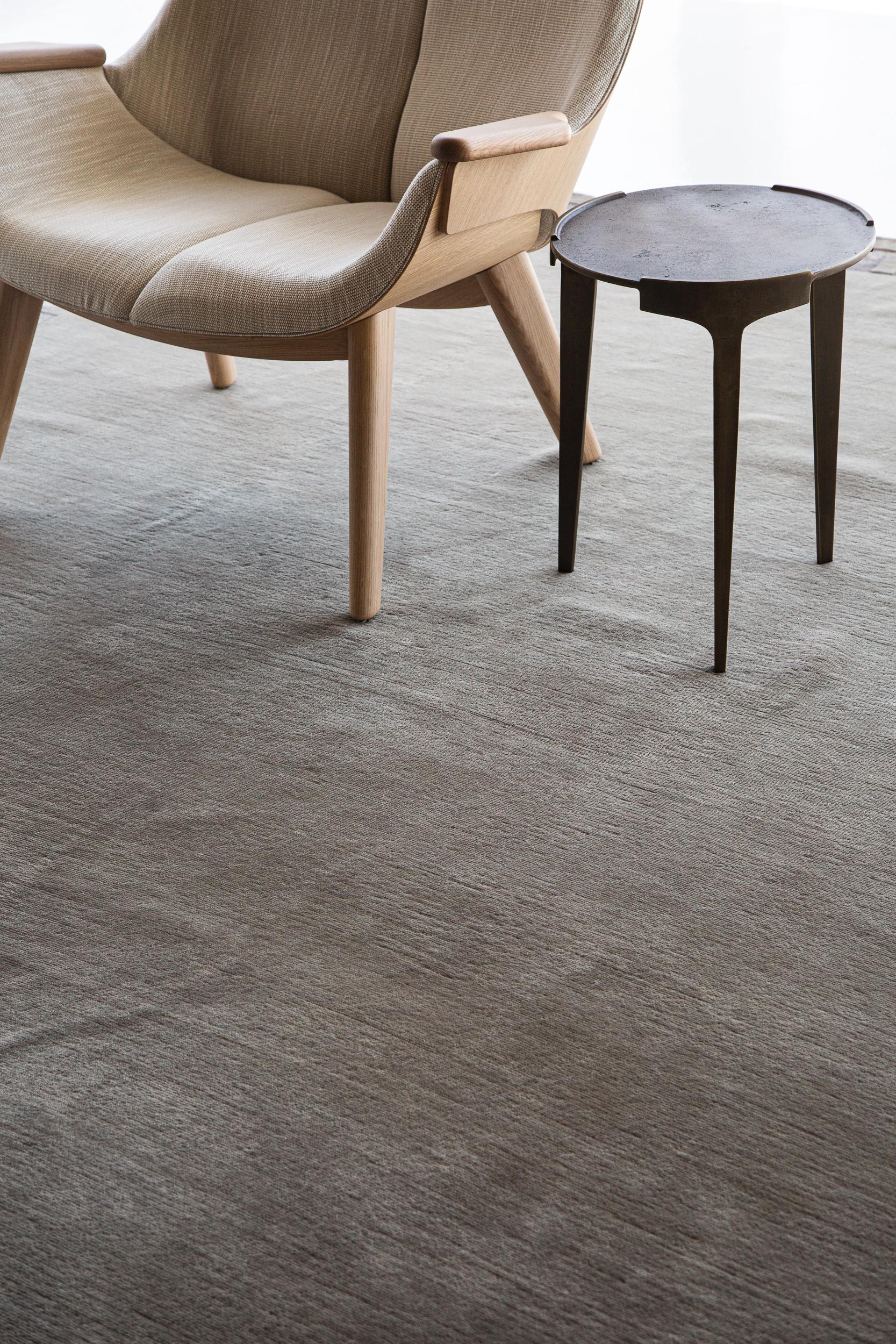 Arcade is a luxurious taupe pile weave hand knotted in wool and bordered with silk design elements. This sleek and sophisticated piece from Mehraban's Design Rhymes Collection inspired by different forms of architectural work in the modern design