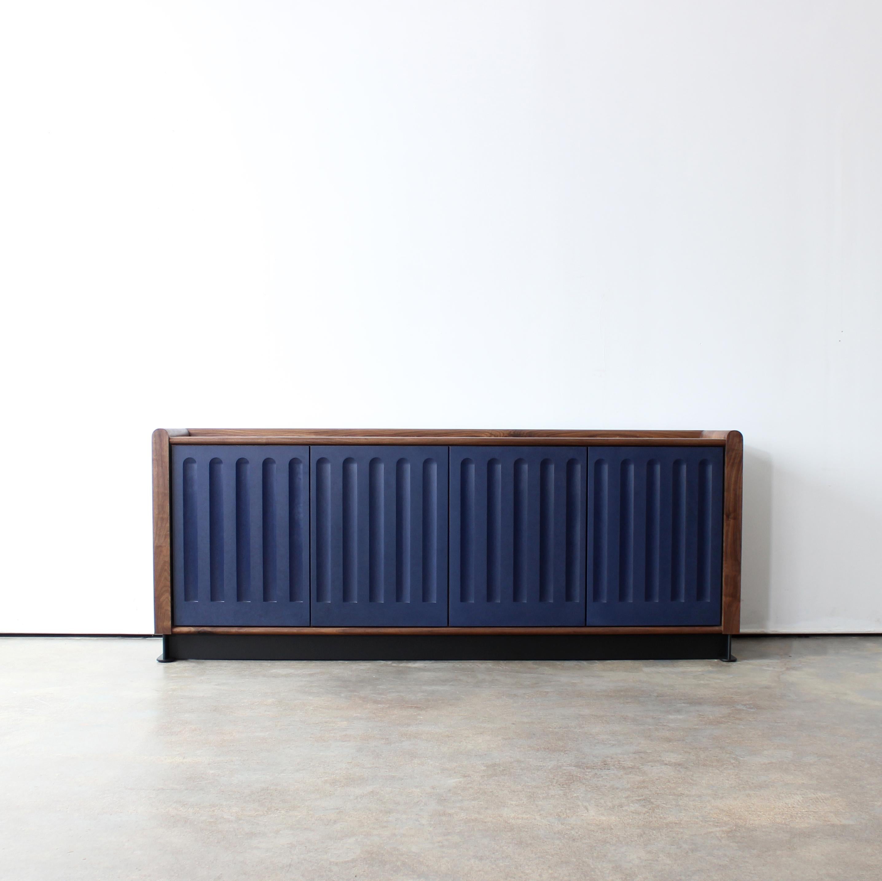 Arcade media console by Crump and Kwash 

Solid wood case / hand rubbed oil finish / recycled paper and resin based composite doors / touch to open soft close doors / adjustable shelving / solid steel patinated base 

Door options - blue canyon,