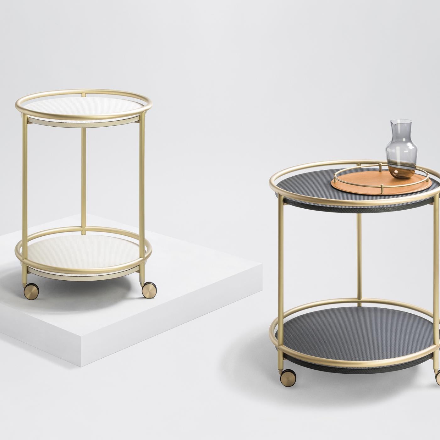 This sophisticated trolley table offers an ideal surface for serving food and beverages, while also serving as a stunning display for plants and collectibles. The coaster wheels allow great movability and its brass structure with two leather-covered