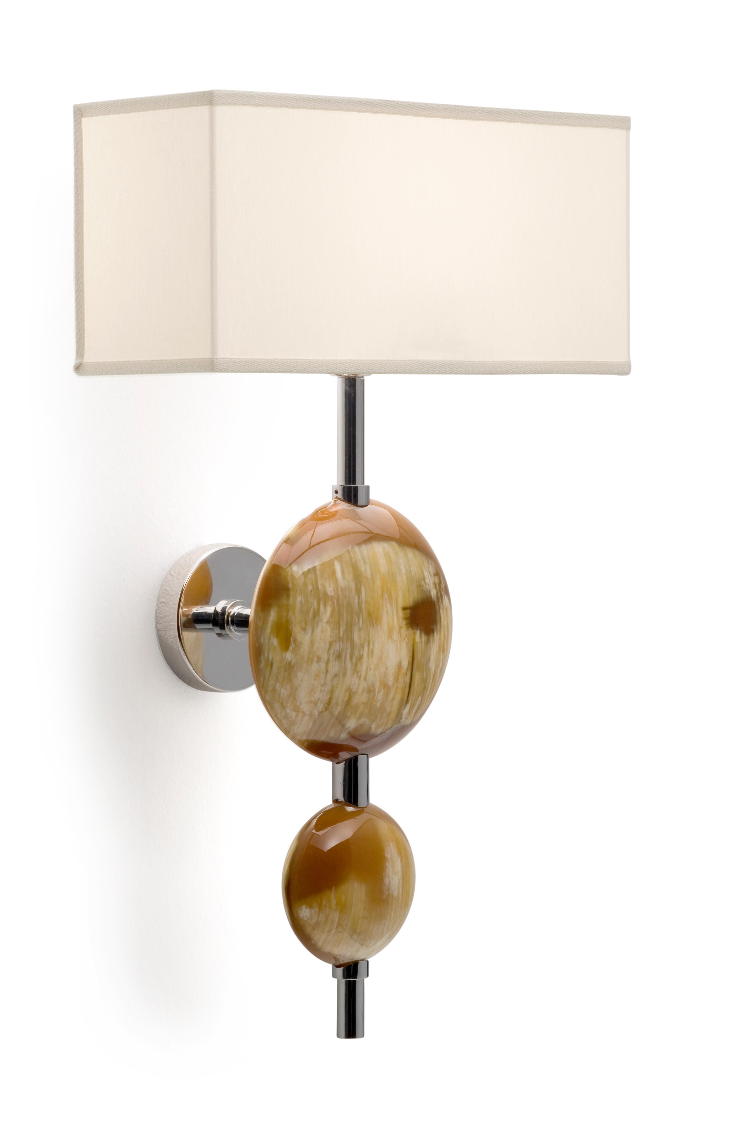Wall sconce in horn and stainless steel. Lampshade in ivory shantung.

Overall Dimensions: W 32 x D 21 x H 52 cm.
