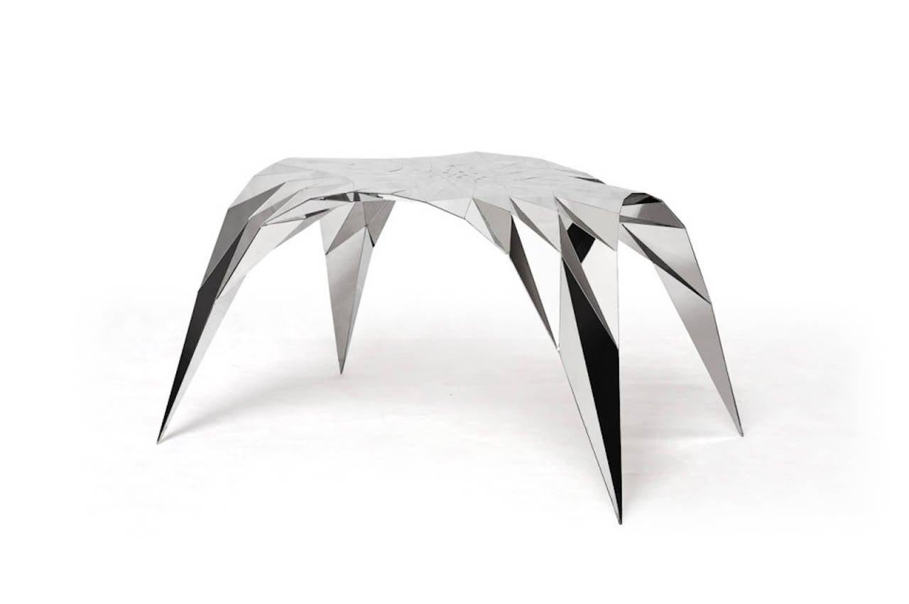 The Arch table, sharing similar characteristics to the stool the table rises from its splayed legs into an elegant faceted arch merging seamlessly into its strong body, creating a striking conflict.

With his practice dedicated to the development