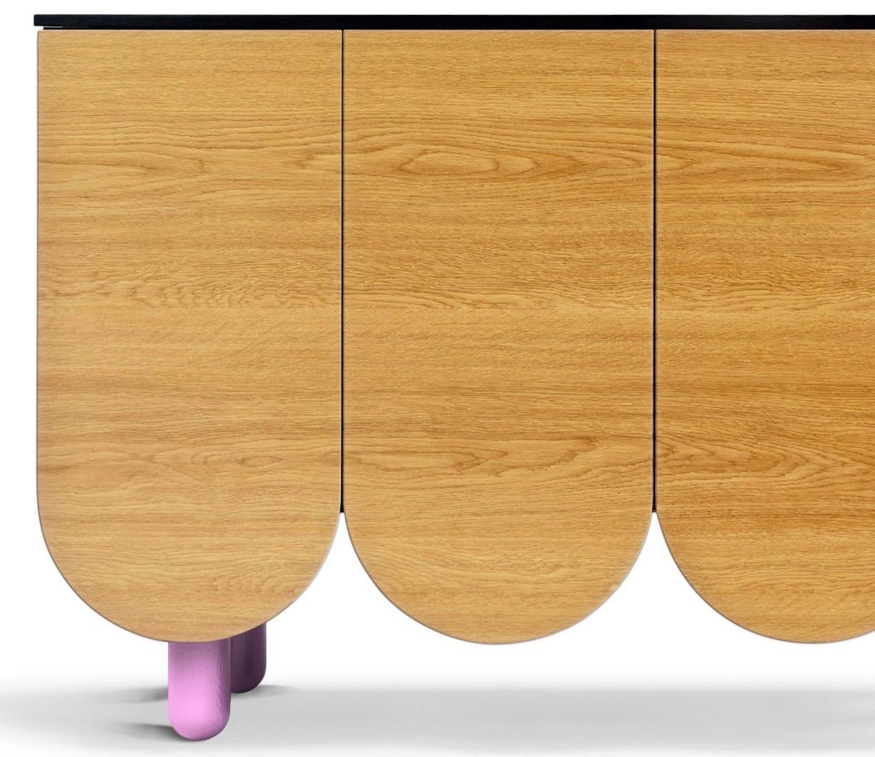 A beautiful Oak Sideboard with pleasing curved doors across which the wood grain follows seamlessly through the doors.
This piece allows for a choice of pink, yellow, black or natural oak feet. If there’s a specific feet colour you’d like, get in