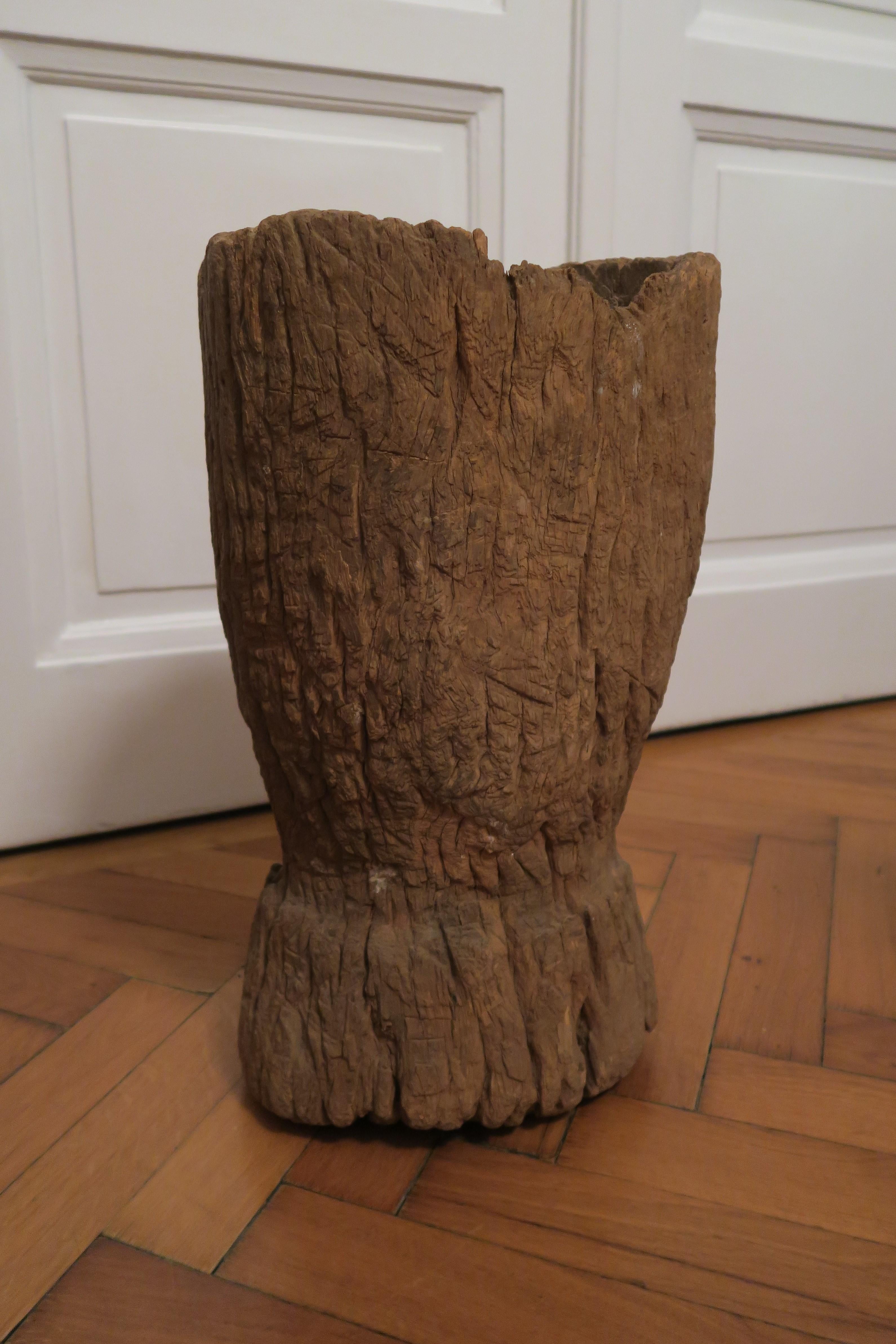 This very massive, exceptional mortar is hand carved from a lovely rust couloured iron wood. It was made in the 19th century on the African continent, possibly in Ghana. The bowl's surface is rough and very detailed. The underside of the foot is