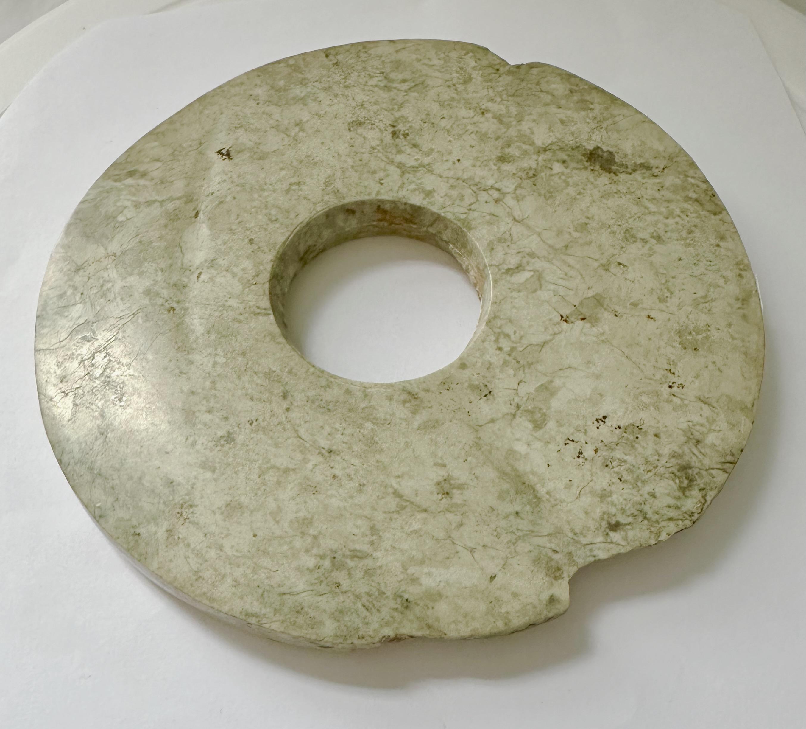 Museum-quality Chinese jade Bi from the Liangzhu period (3300-2200 BC). For the Liangzhu, jade was the primary material through which the secular and religious authority of its leaders was expressed.

Jade Bi discs, which are believed to represent
