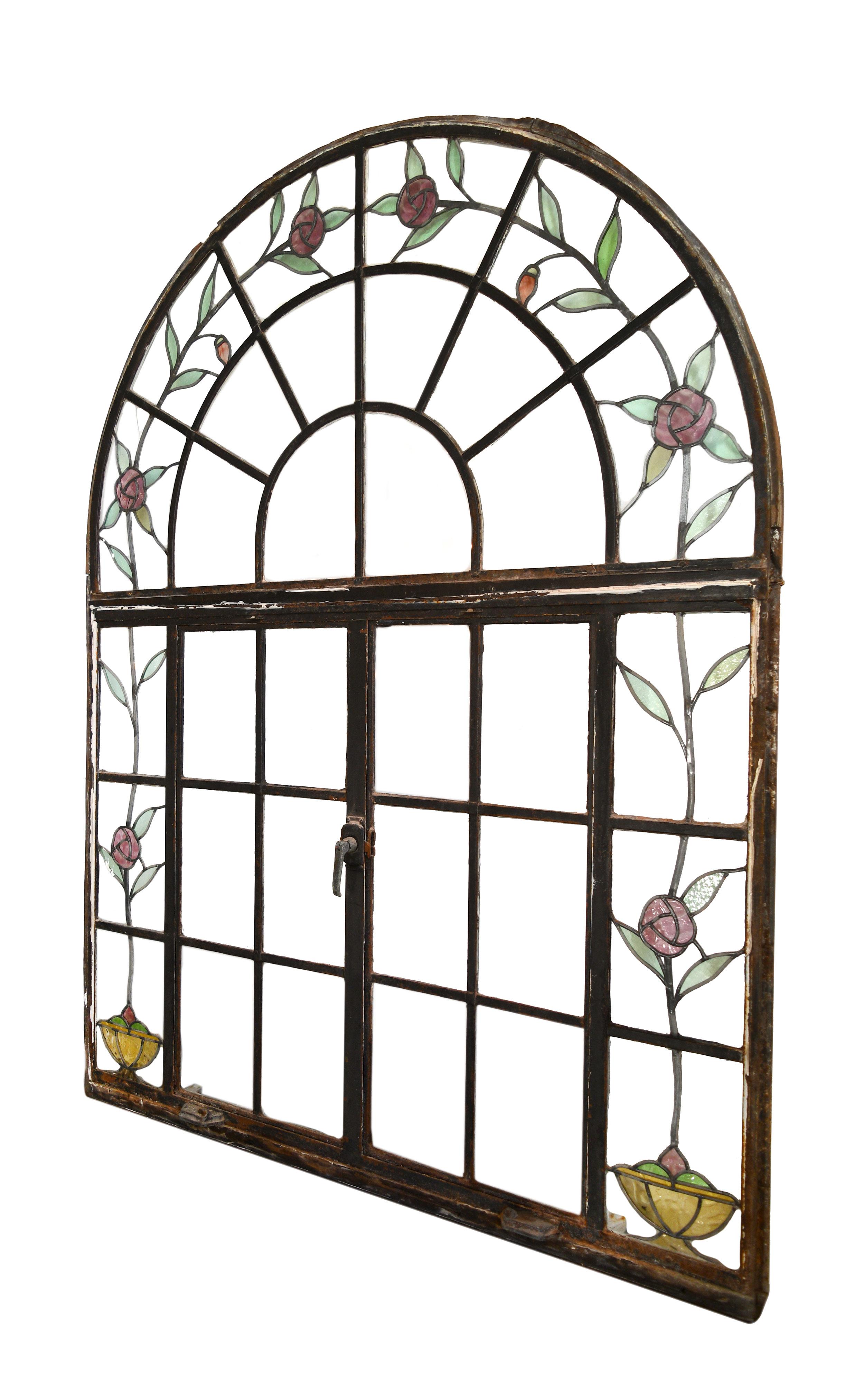 This stunning casement window features lovely stained glass roses throughout the uniquely arched frame. This window is in great condition with only one small crack within the glass.
  